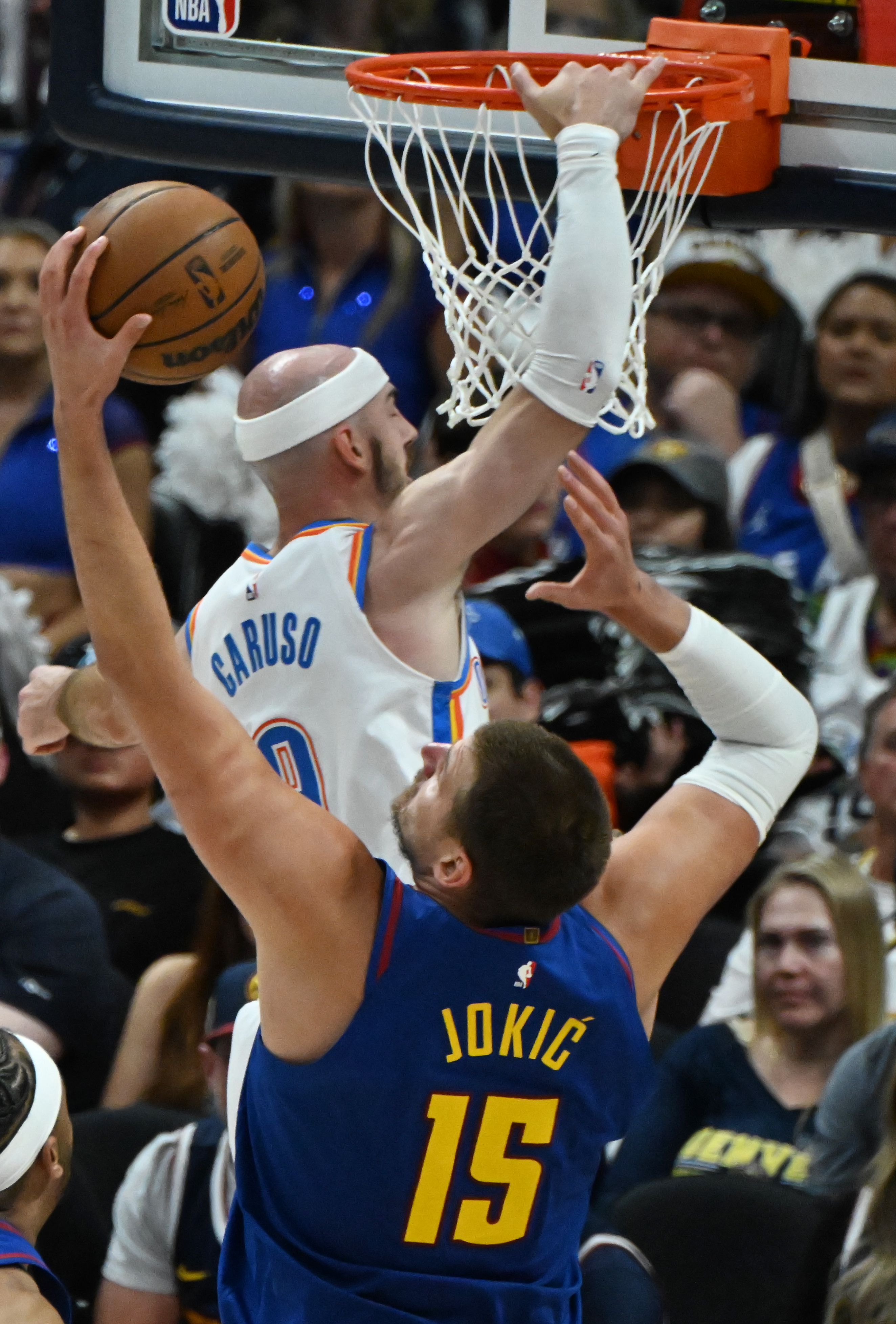 Denver Nuggets center Nikola Jokic (15) gets the rebound of a missed shot by Oklahoma City Thunder guard Alex Caruso (9) during the 2nd quarter of game 3 of round 2 of the Western Conference Championship at Ball Arena on Friday, May 9, 2025. (Jerilee Bennett,The Gazette)