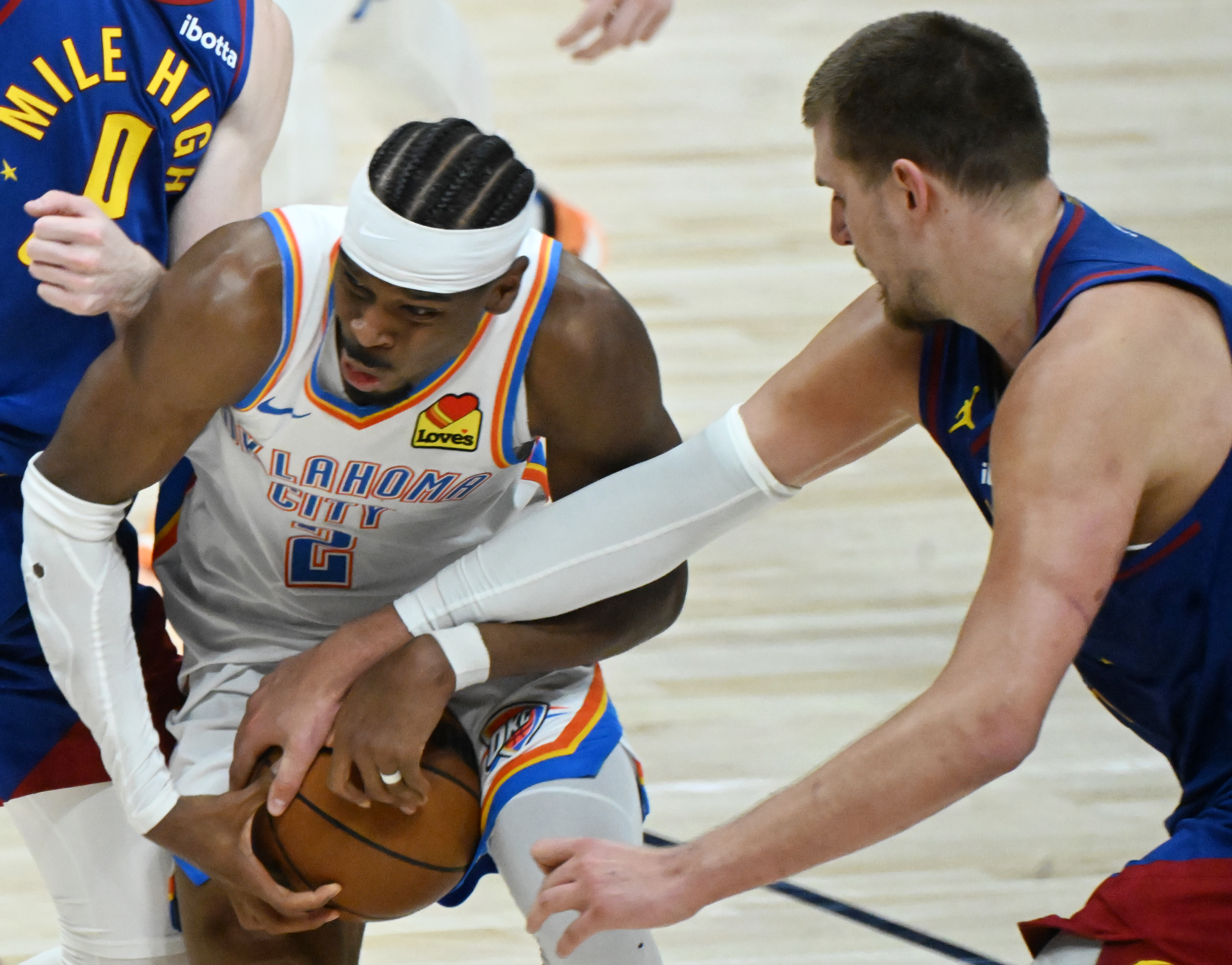 Denver Nuggets center Nikola Jokic (15) defends Oklahoma City Thunder guard Shai Gilgeous-Alexander (2) during overtime of game 3 of round 2 of the Western Conference Championship at Ball Arena on Friday, May 9, 2025. The Nuggets won the game 113-104. (Jerilee Bennett,The Gazette)