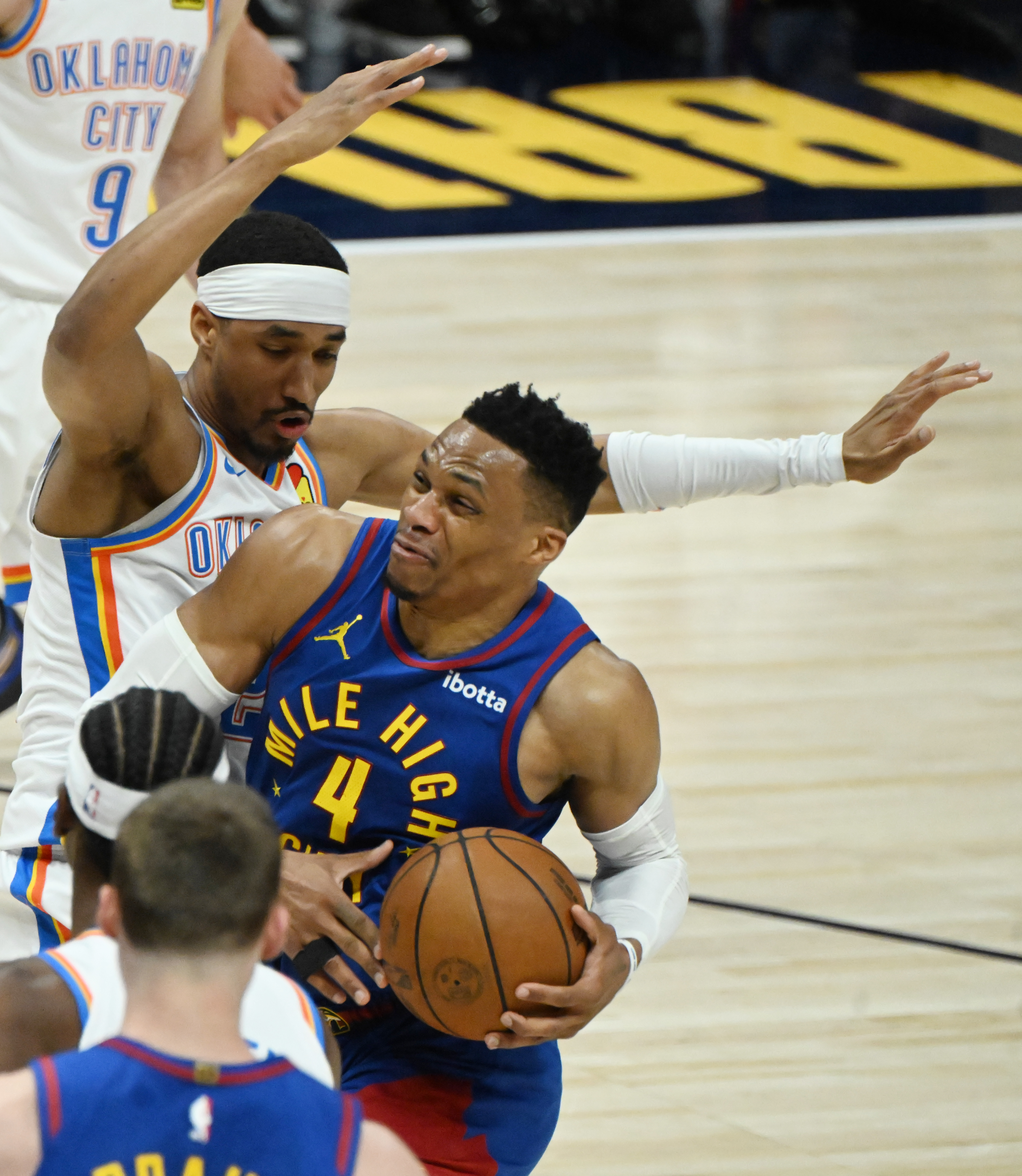 Denver Nuggets guard Russell Westbrook (4) is pressured by Oklahoma City Thunder guard Aaron Wiggins (21) as he heads for the basket during the 2nd quarter of game 3 of round 2 of the Western Conference Championship at Ball Arena on Friday, May 9, 2025. (Jerilee Bennett,The Gazette)