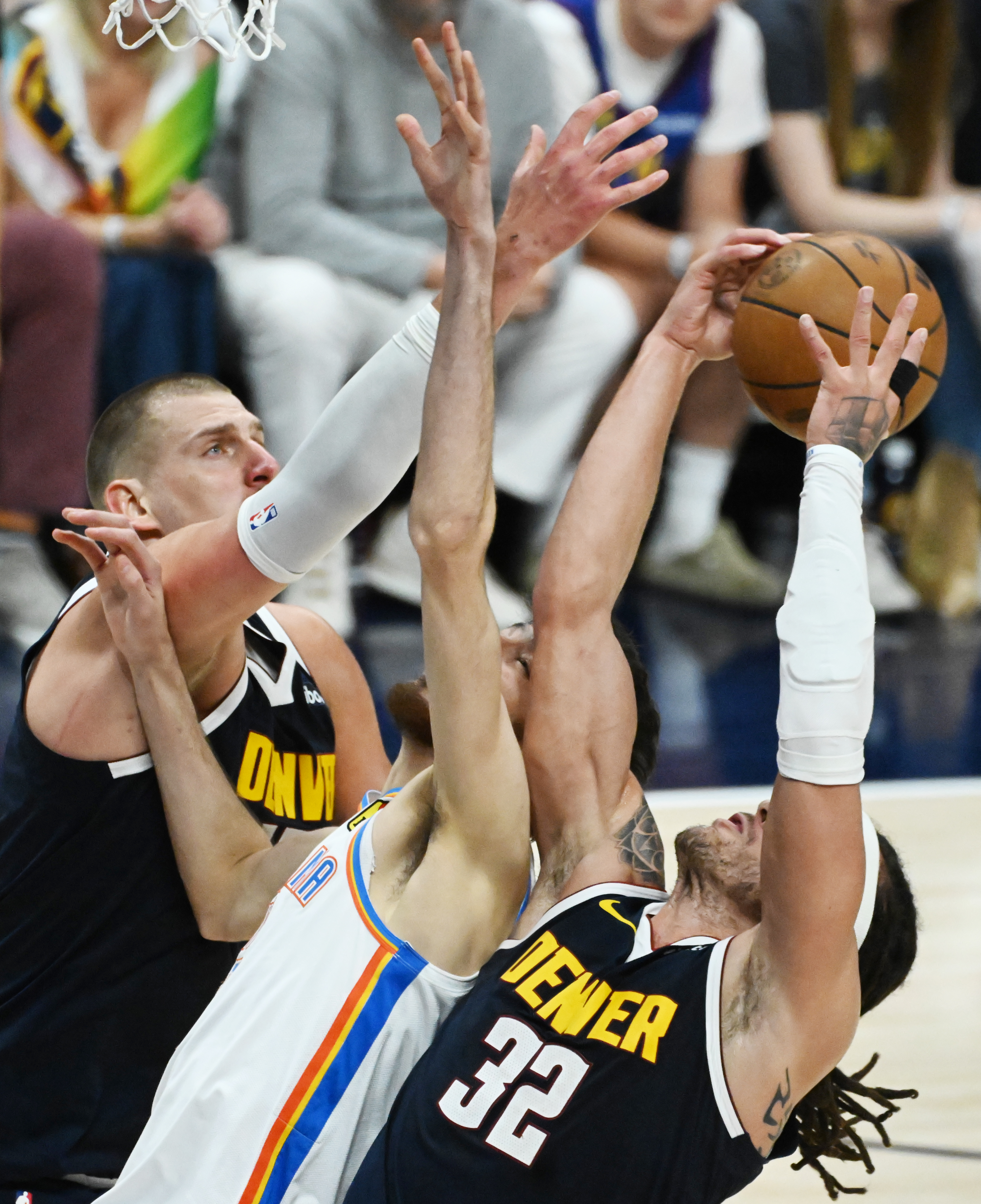 Denver Nuggets forward Aaron Gordon (32) gets a defensive rebound out of the hans of Oklahoma City Thunder guard Alex Caruso (9) during the 4th quarter of game 4 of the second round of the Western Conference Championship at Ball Arena on Sunday, May 11, 2025. (Jerilee Bennett,The Gazette)