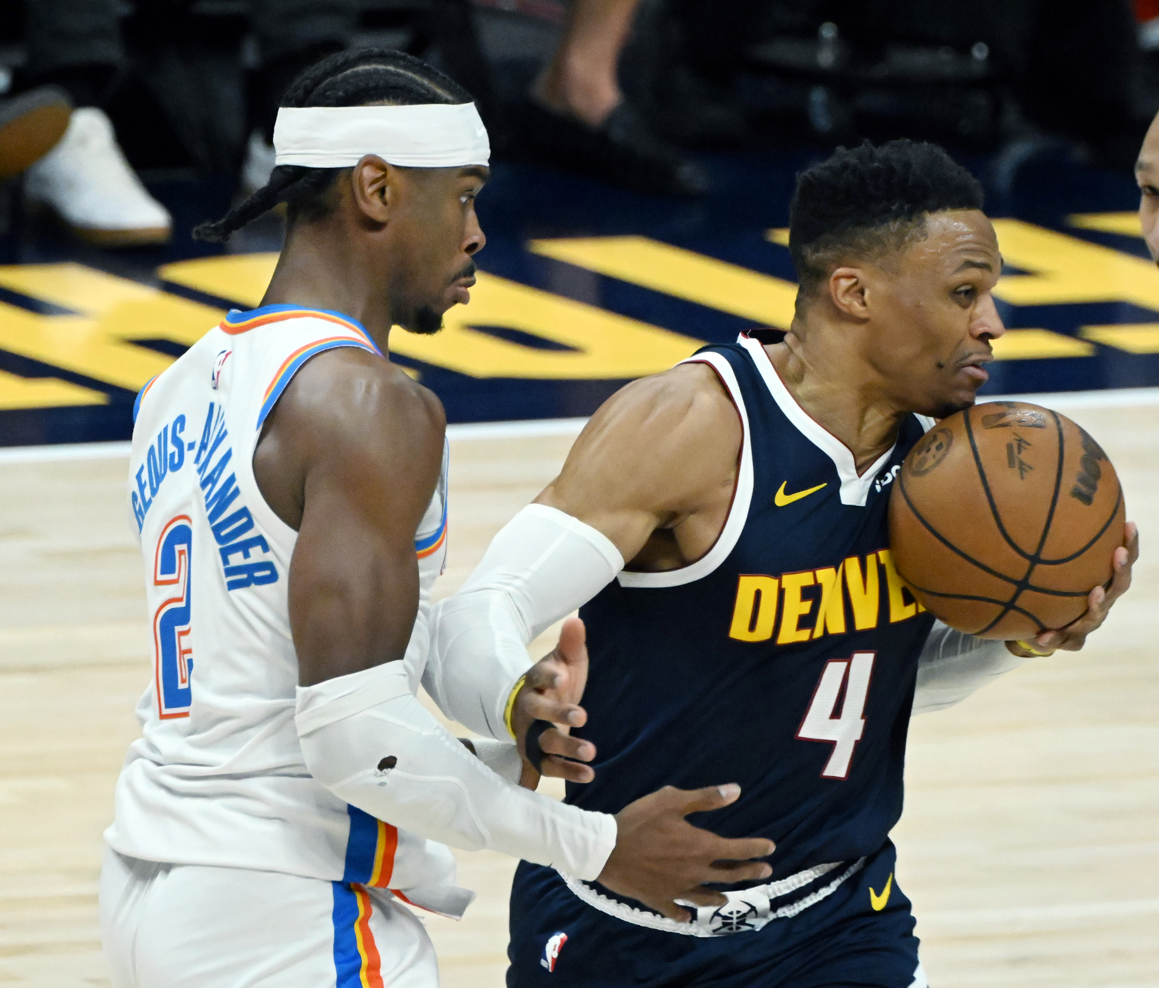 Denver Nuggets guard Russell Westbrook (4) is defended by Oklahoma City Thunder guard Shai Gilgeous-Alexander (2) during the 1st quarter of game 4 of the second round of the Western Conference Championship at Ball Arena on Sunday, May 11, 2025. (Jerilee Bennett,The Gazette)