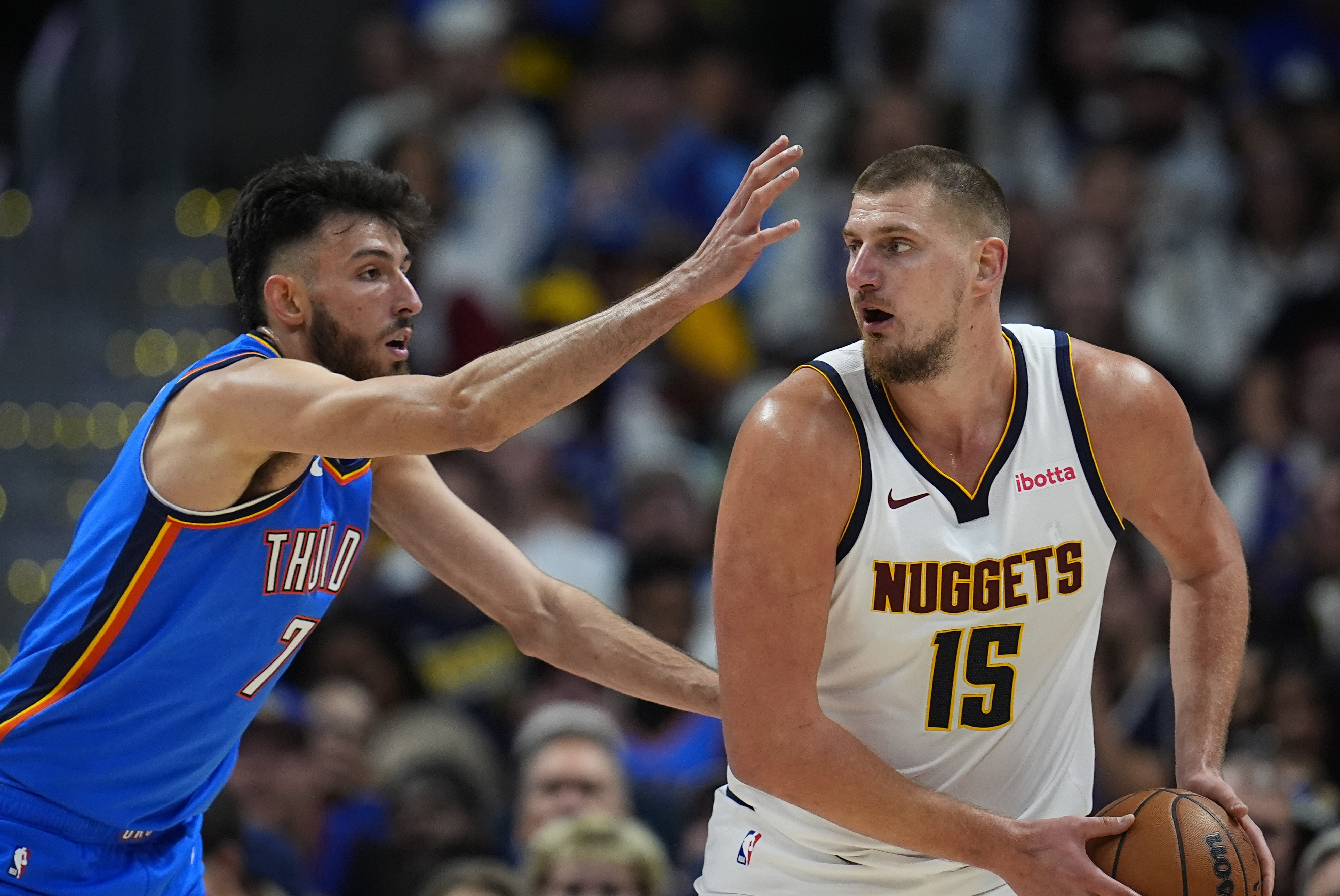 Oklahoma City Thunder forward Chet Holmgren (7) covers Denver Nuggets center Nikola Jokic (15) in the second half of an NBA basketball game Thursday, Oct. 24, 2024, in Denver. (AP Photo/David Zalubowski) (David Zalubowski)