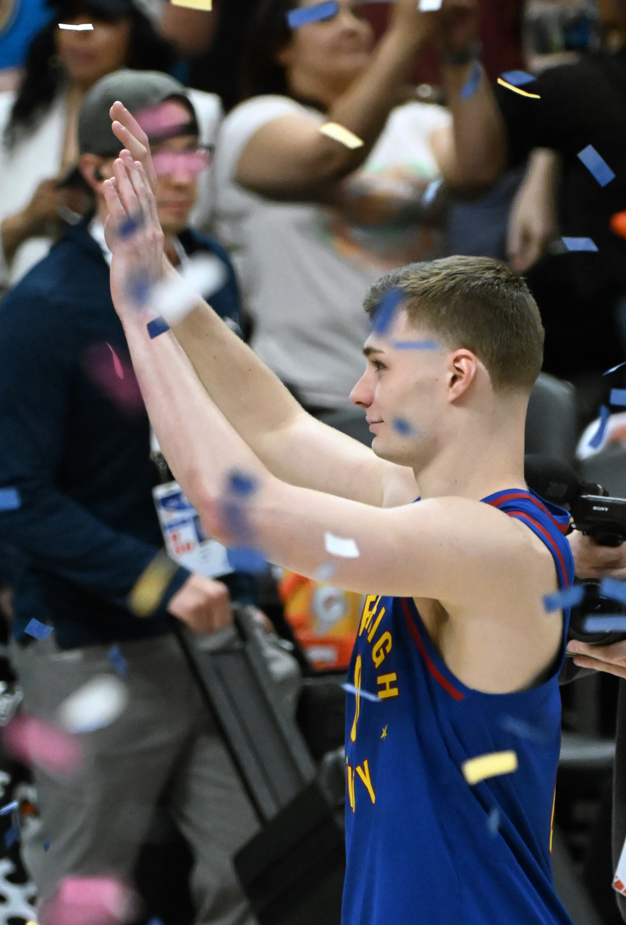 Denver Nuggets guard Christian Braun (0) waves to the crowd through the confetti after Game 7 of Round 1 of the Western Conference Championship on Saturday, April 3, 2025. The Nuggets defeated the Clippers 120-101 and will play the Thunder in the second round. (Jerilee Bennett,The Gazette)
