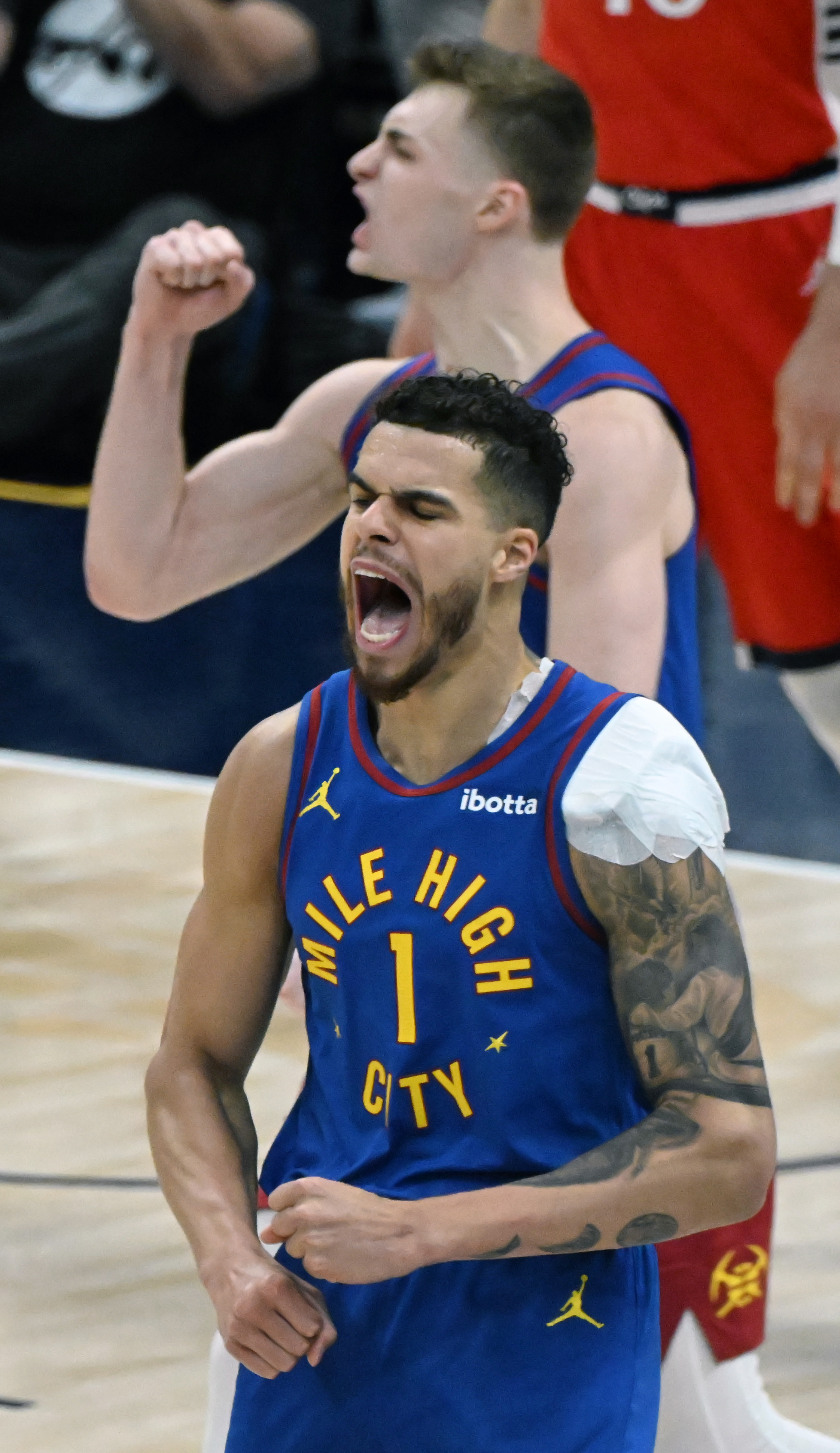 Denver Nuggets forward Michael Porter Jr. (1) celebrates a basket with Denver Nuggets guard Christian Braun (0) during the third quarter as the Nuggets started their rout of the Clippers in Game 7 of Round 1 of the Western Conference Championship on Saturday, April 3, 2025. The Nuggets defeated the Clippers 120-101 and will play the Thunder in the second round. (Jerilee Bennett,The Gazette)