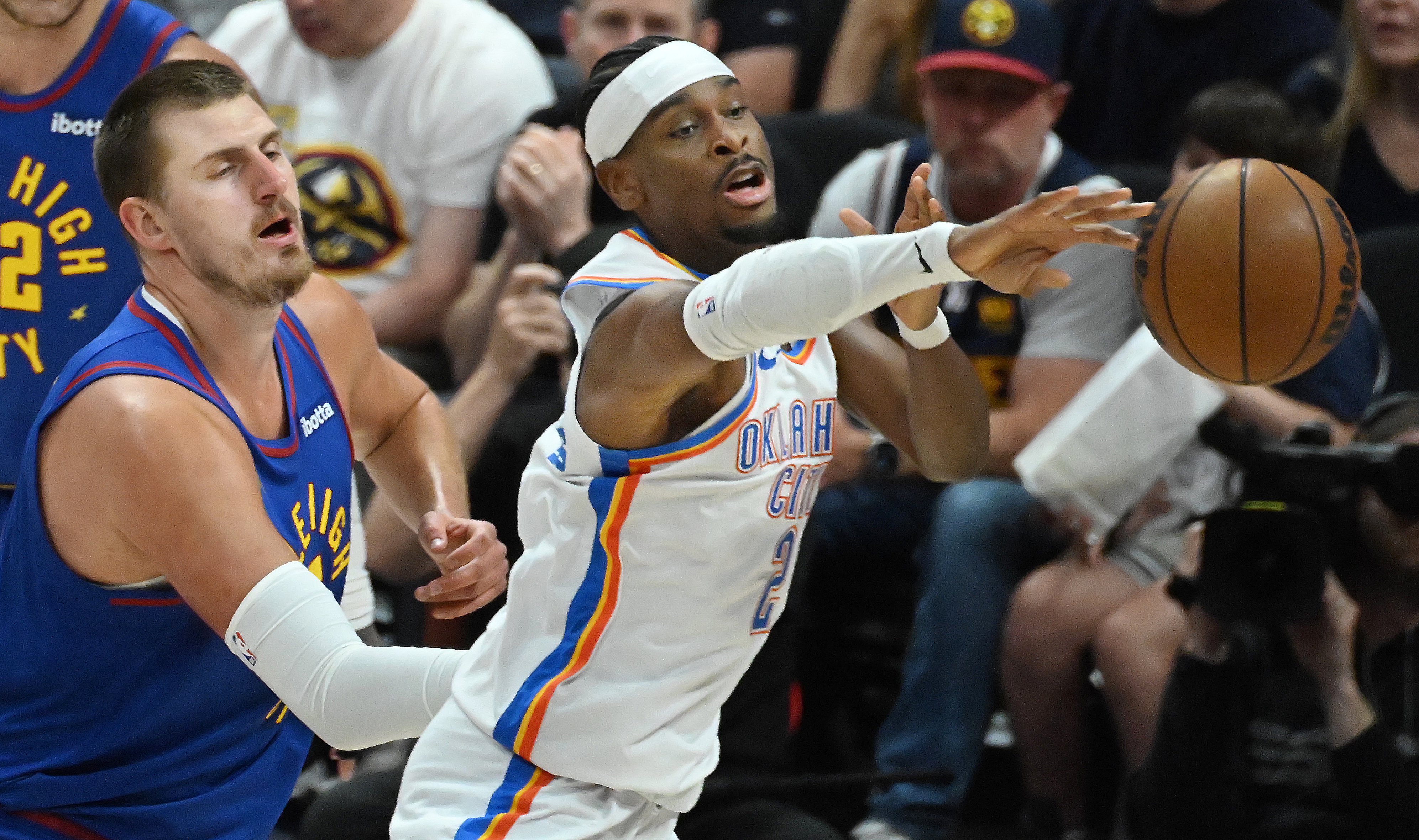 Denver Nuggets center Nikola Jokic (15) defends Oklahoma City Thunder guard Shai Gilgeous-Alexander (2) as he passes the ball during the first quarter of game 3 of round 2 of the Western Conference Championship at Ball Arena on Friday, May 9, 2025. (Jerilee Bennett,The Gazette)