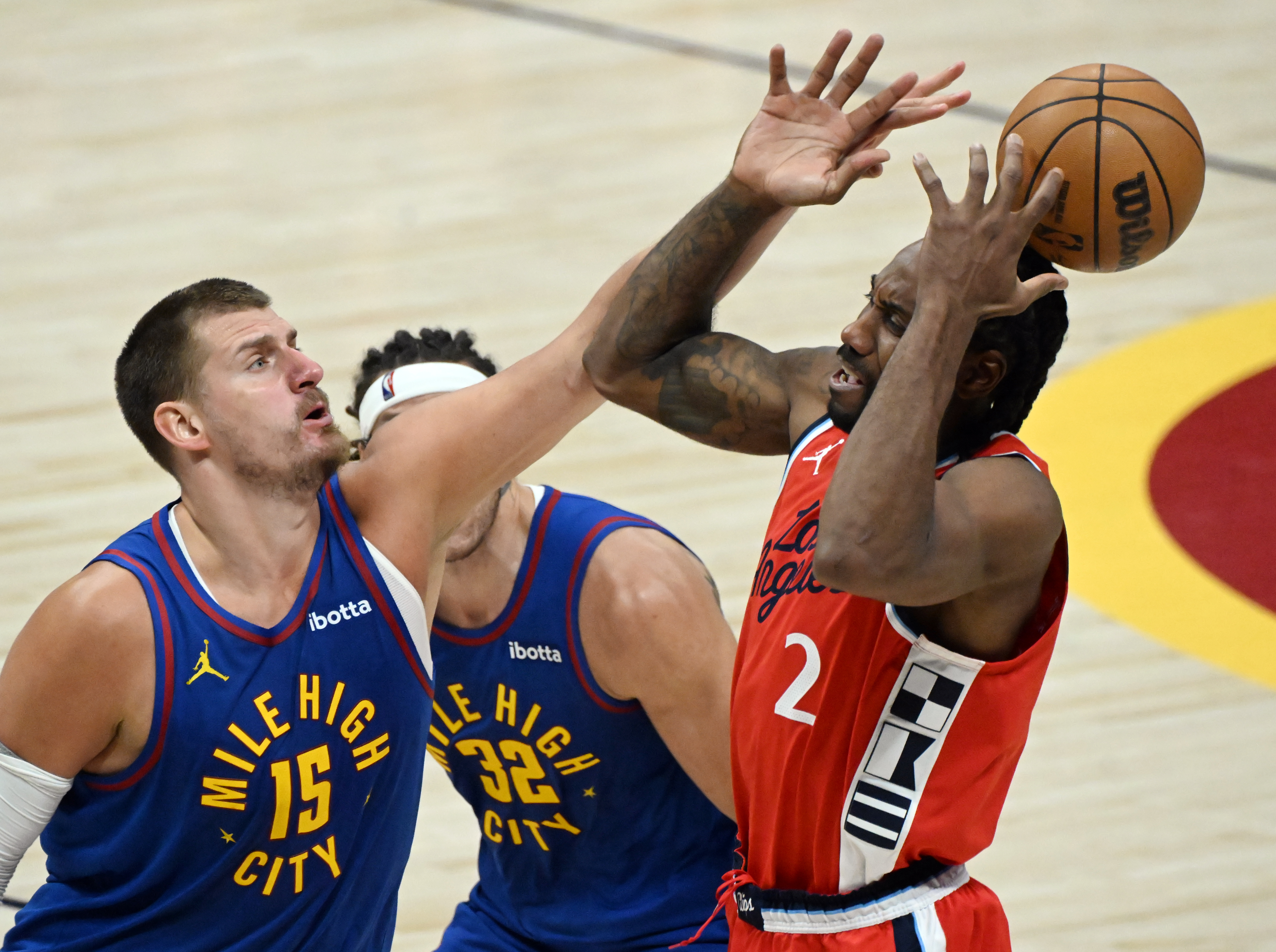 Denver Nuggets center Nikola Jokic (15) knocks the ball away from Clippers forward Kawhi Leonard (2) during the third quarter ofGame 7 of Round 1 of the Western Conference Championship on Saturday, April 3, 2025. The Nuggets defeated the Clippers 120-101 and will play the Thunder in the second round. (Jerilee Bennett,The Gazette)