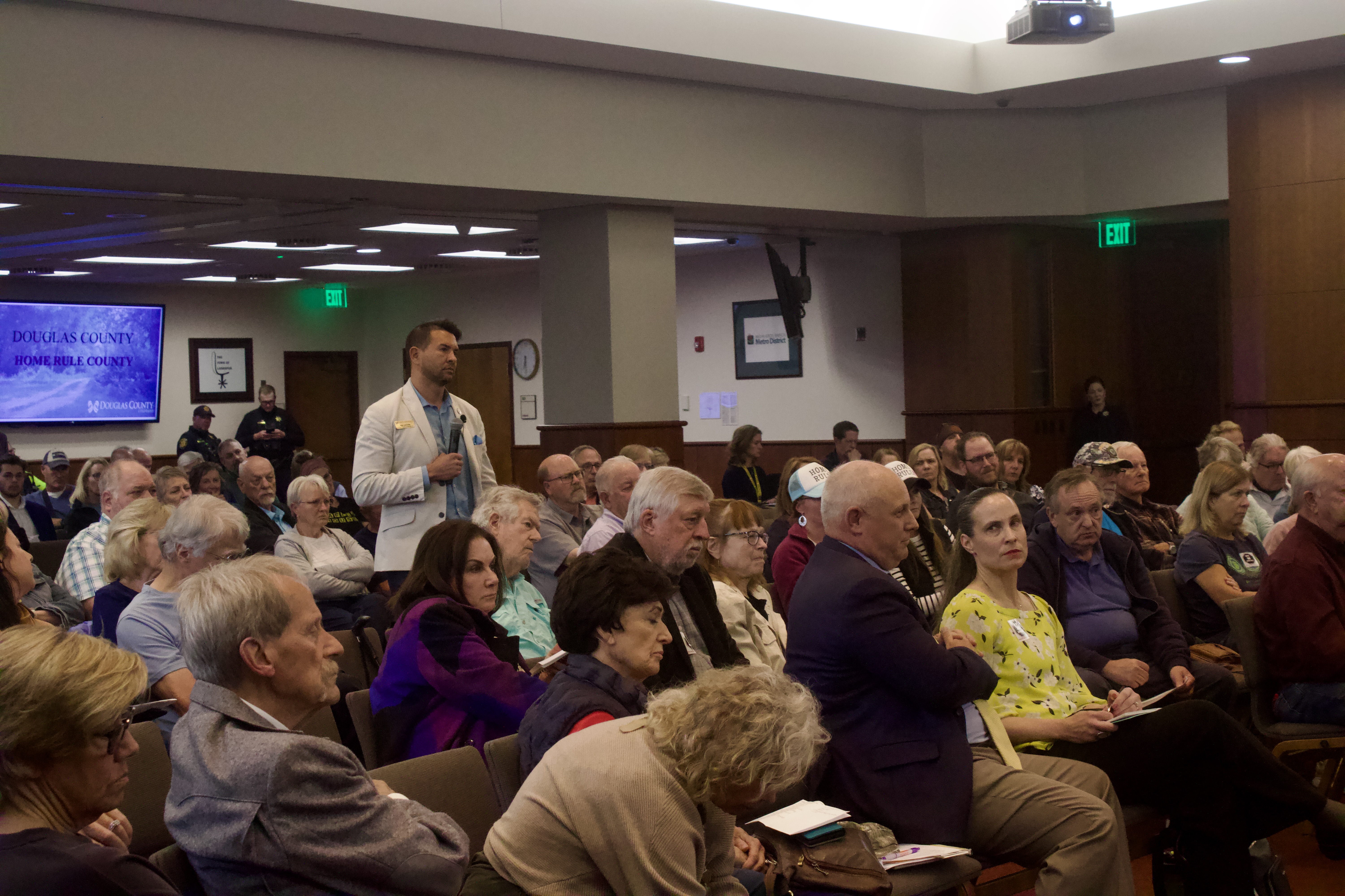 Douglas County Commissioner Abe Laydon stands in the middle of dozens of local residents during a town hall discussing the county's efforts for
