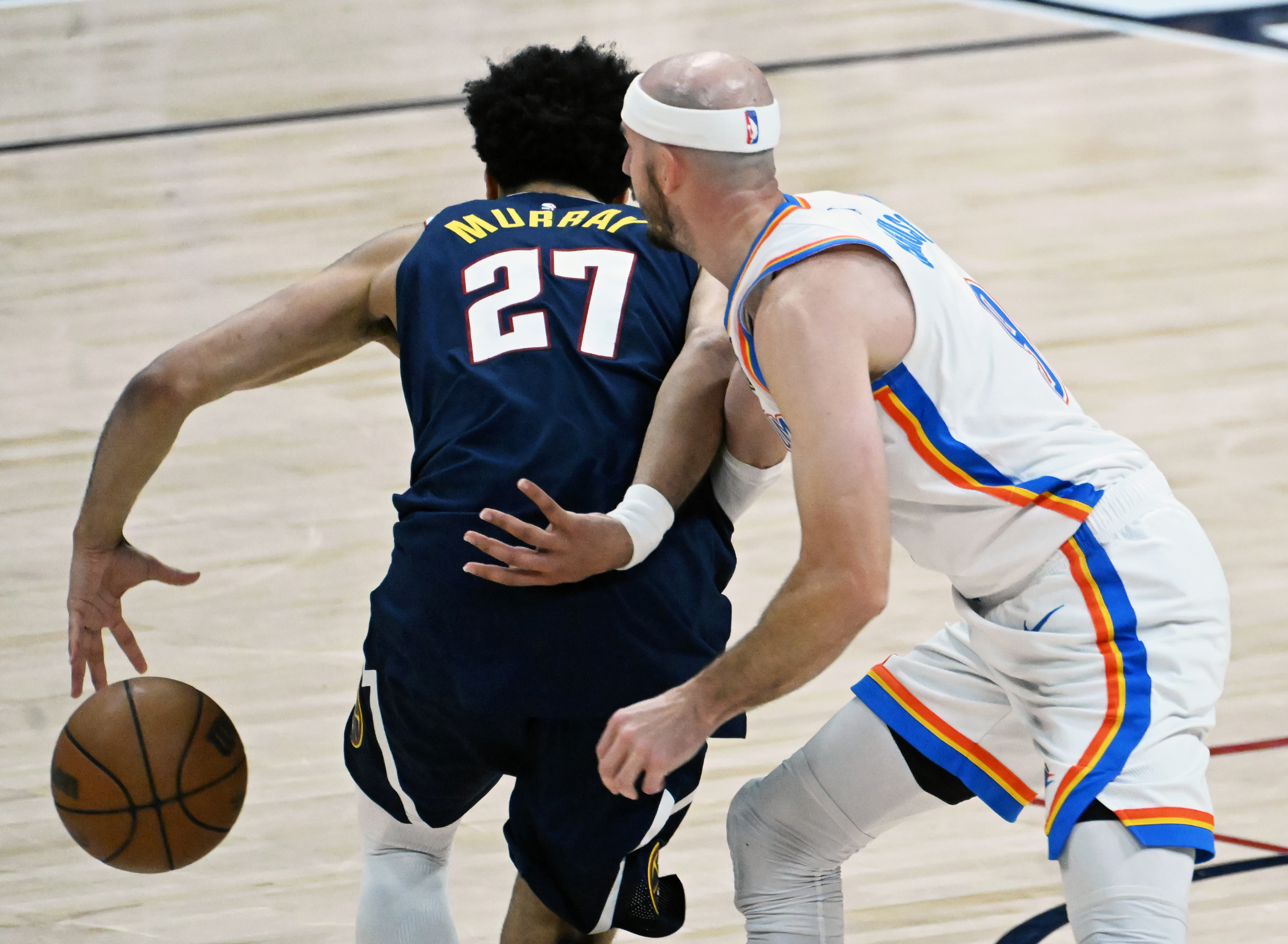 Oklahoma City Thunder guard Alex Caruso (9) knocks the ball away from Denver Nuggets guard Jamal Murray (27) during the 4th quarter of game 4 of the second round of the Western Conference Championship at Ball Arena on Sunday, May 11, 2025. (Jerilee Bennett,The Gazette)