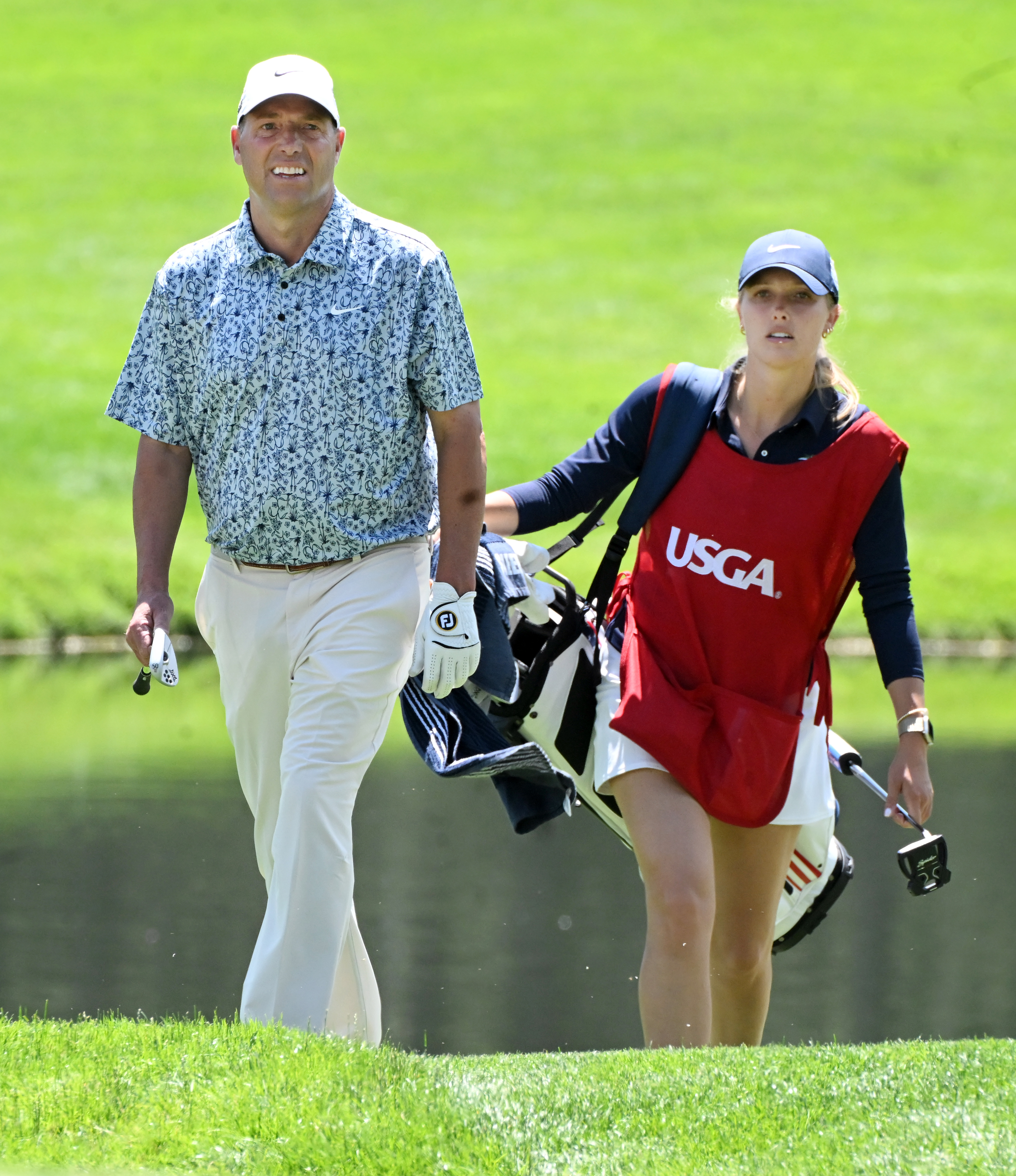 Matt Schalk from Erie, Colorado, walks up the hill to the 18th green with his daughter Hailey Schalk by his side on the first day of play at the U.S. Senior Open Championship at the Broadmoor Golf Club on Thursday, June 26, 2025. (Jerilee Bennett,The Gazette)