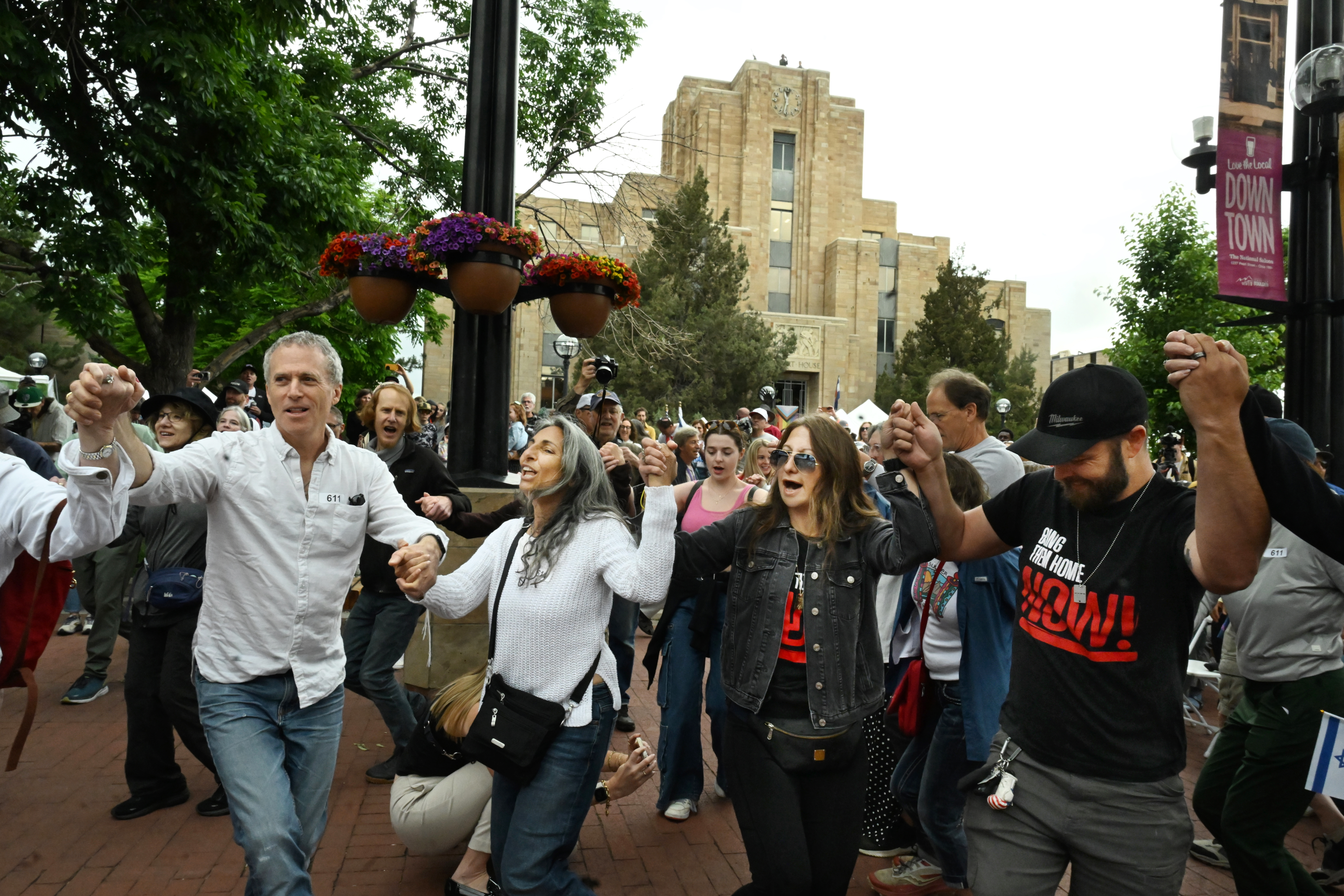 Attendees participate in a Jewish dance before a the Run for Their Lives walk to show resilience and solidarity in the face of the June 1 antisemitic terror attack on the Pearl Street Mall in Boulder. They walked in the same location as last week along the Pearl Street Mall on Sunday, June 8, 2025. Last weeks walk ended with a man using makeshift molotov cocktails to set the peaceful protesters on fire.
