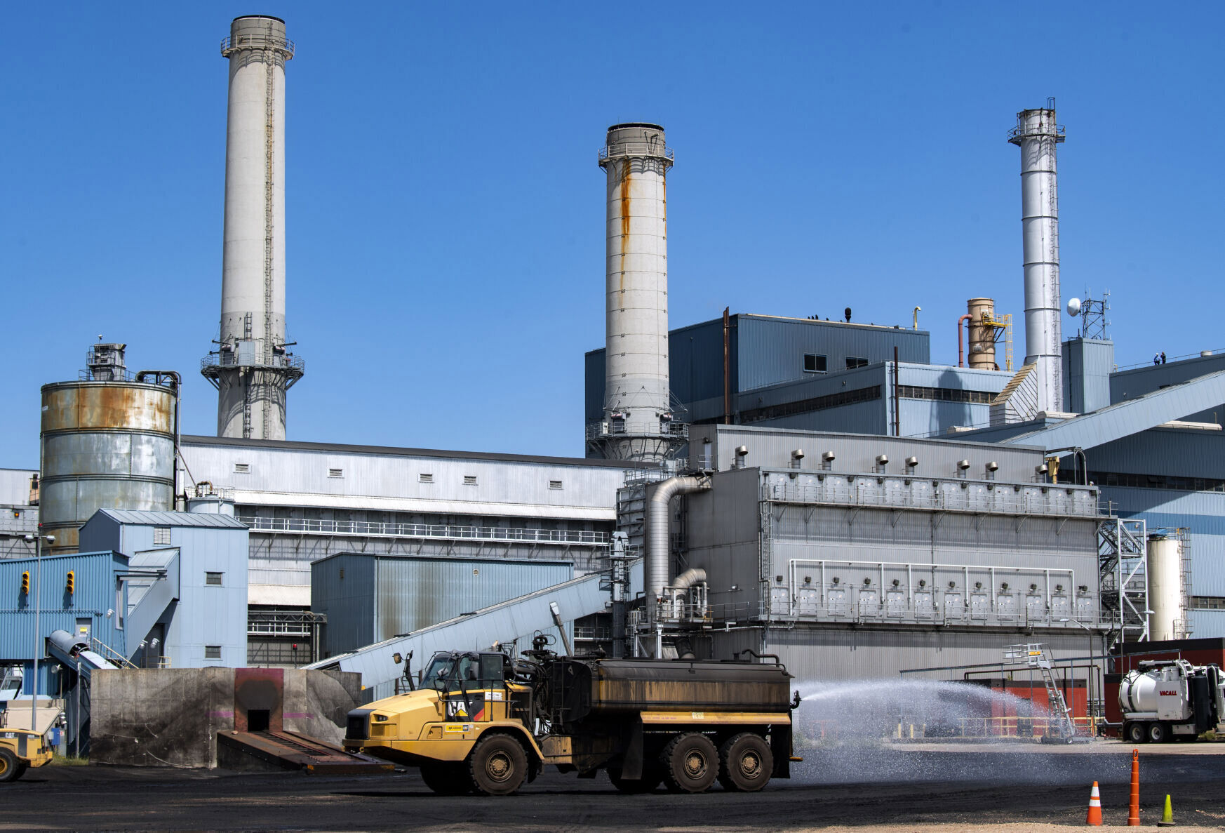 A tankers sprays water on the coal dust after the last chuck of coal was loaded onto the conveyor Friday, Aug. 27, 2021, at the Martin Drake Power Plant in downtown Colorado Springs. The power plant has been using coal since it began providing electricity to the city in 1925. The plant will continue to operate on natural gas until the end 2022 when it will be demolished. (The Gazette, Christian Murdock)