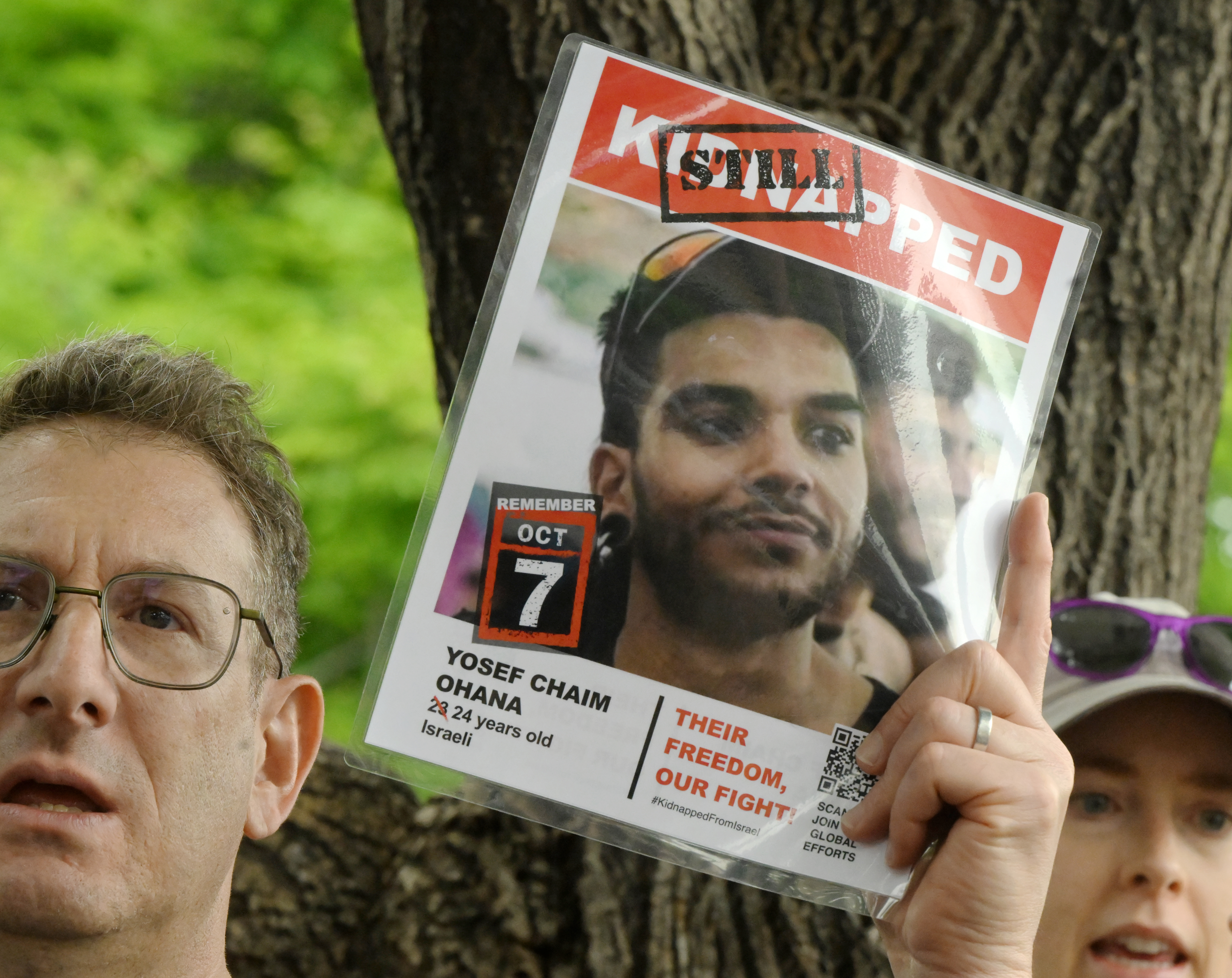 A man holds up a photo of hostage that was kidnapped on Oct. 7, 2023 by Hamas after a Run For Their Lives walk at the Pearl Street Mall on Sunday, June 8, 2025. They walked in the same location as last week along the Pearl Street Mall on Sunday, June 8, 2025. Last weeks walk ended with a man using makeshift molotov cocktails to set the peaceful protesters on fire. The walk has been held every week in cities around the country to make sure that the hostages in Gaza, that were taken on Oct. 7, 2023, are not forgotten.