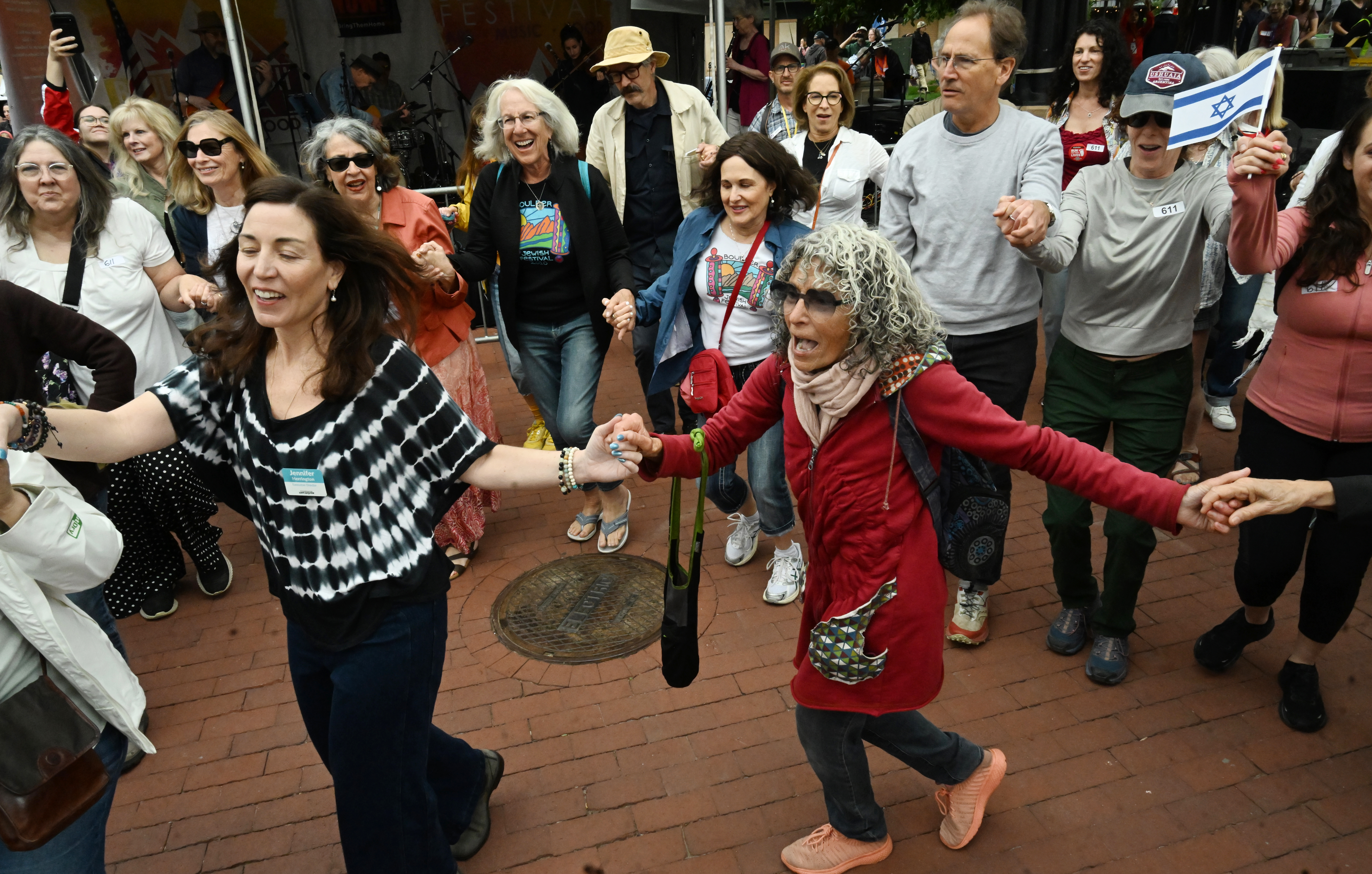 Jennifer Herrington and Kriya Goodman and others participate in a Jewish dance before a the Run for Their Lives walk to show resilience and solidarity in the face of the June 1 antisemitic terror attack. They walked in the same location as last week along the Pearl Street Mall on Sunday, June 8, 2025. Last weeks walk ended with a man using makeshift molotov cocktails to set the peaceful protesters on fire.