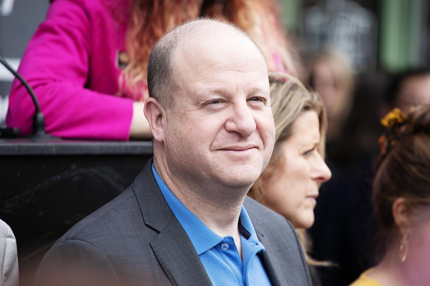 Gov. Jared Polis looks out at the crowd
