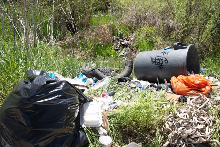 Trash is left in a section of McIntyre Gulch in Lakewood, Colo.