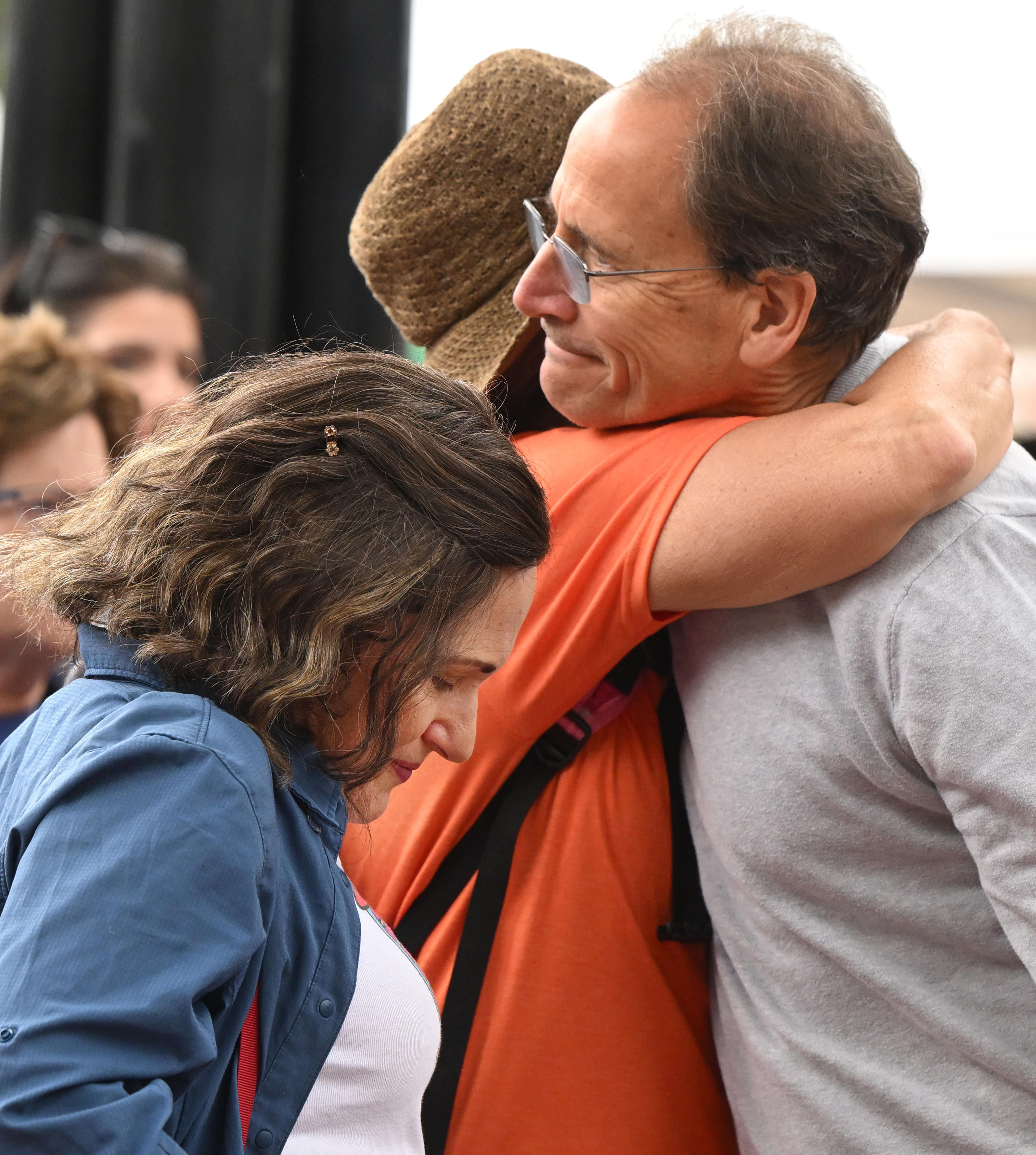 Kim Leisner Korevaar, Jackie Seltzer, and David Korevaar (left to right), members of the Boulder Jewish community, comfort each other before the Run For Their Lives walk at the Pearl Street Mall . They walked in the same location as last week along the Pearl Street Mall on Sunday, June 8, 2025. Last weeks walk ended with a man using makeshift molotov cocktails to set the peaceful protesters on fire. The walk has been held every week in cities around the country to make sure that the hostages in Gaza, that were taken on Oct. 7, 2023, are not forgotten.