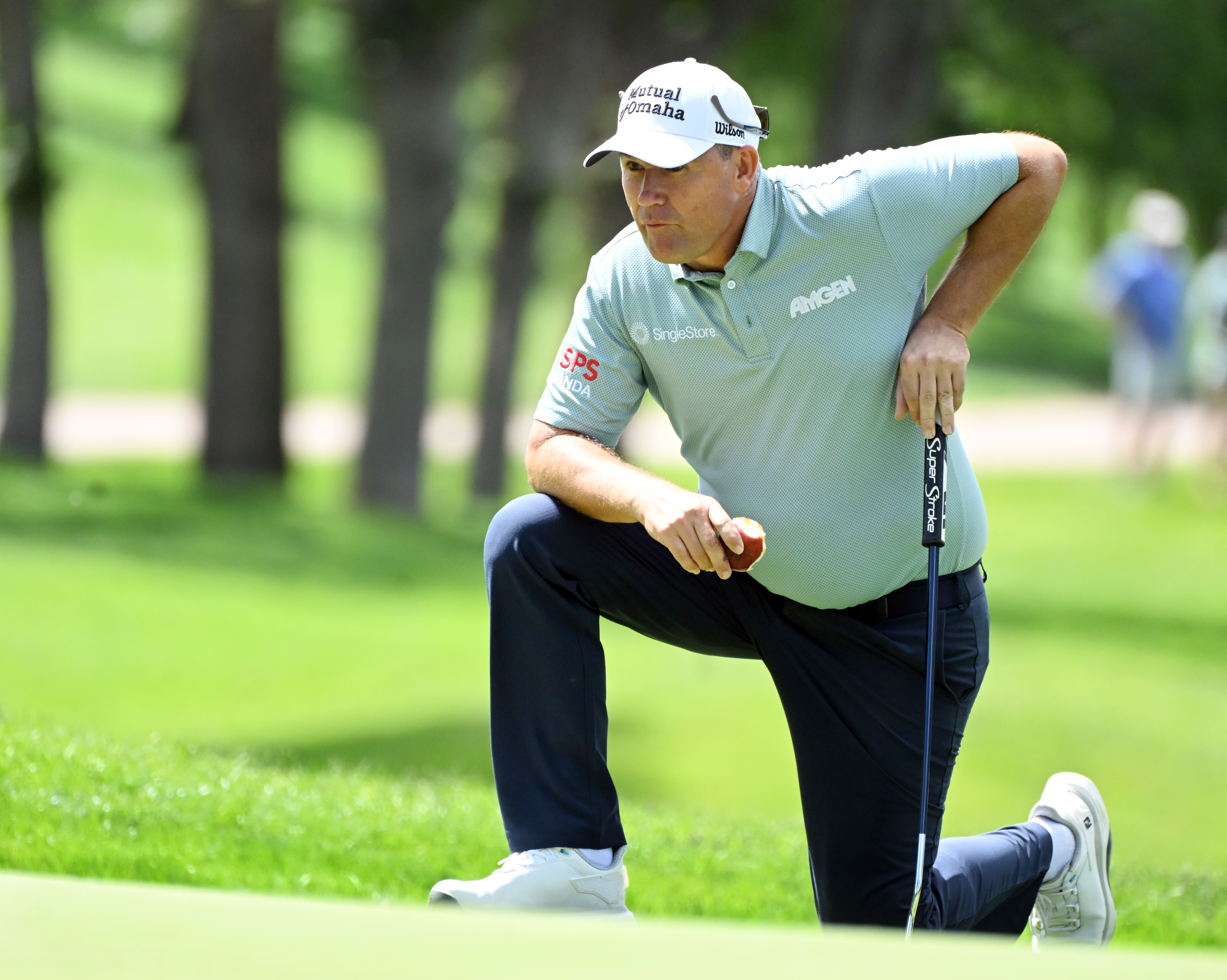 Padraig Harrington snacks on an apple while lining up a putt on the 10th hole on the first day of play at the U.S. Senior Open Championship at the Broadmoor Golf Club in Colorado Springs, Colorado, on Thursday, June 26, 2025. Harrington ended up in a 2-way tie for first place with a -3. (Jerilee Bennett,The Gazette)