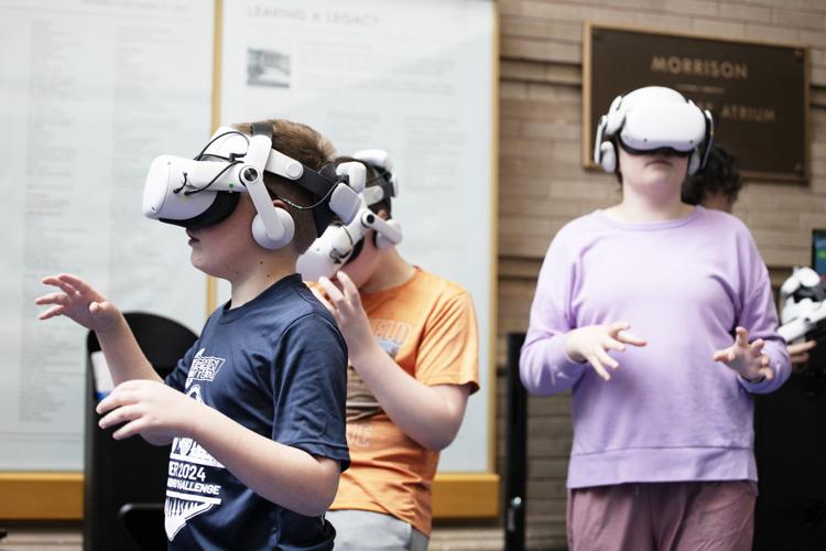 From left, Barrett, Finley and Brooklyn H. wear virtual reality headsets