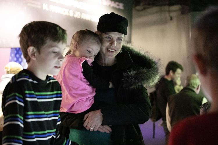 Stacie Graber and her children, Corrie, 3, and Eric, 10, look at an interactive exhibit