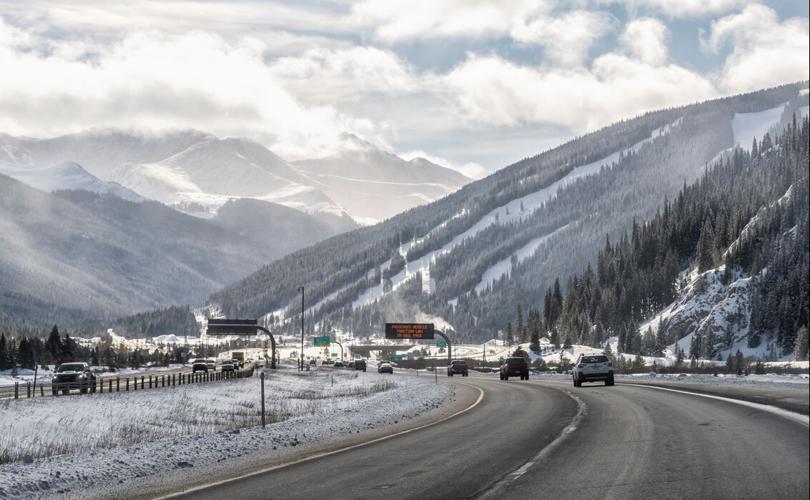 Colorado winter snow highway i70 Vail Pass with cars traffic and Gore Range snowcapped