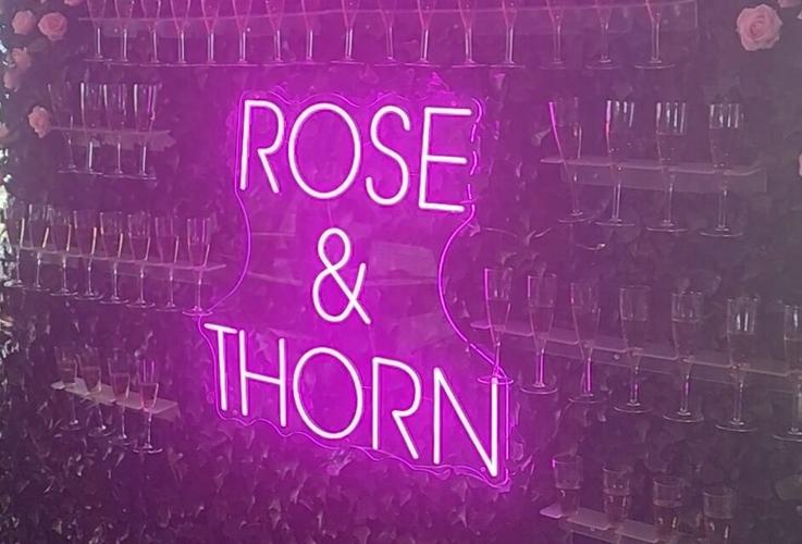 Rose & Thorn’s neon champagne wall adds glam to RiNo rooftop bar
