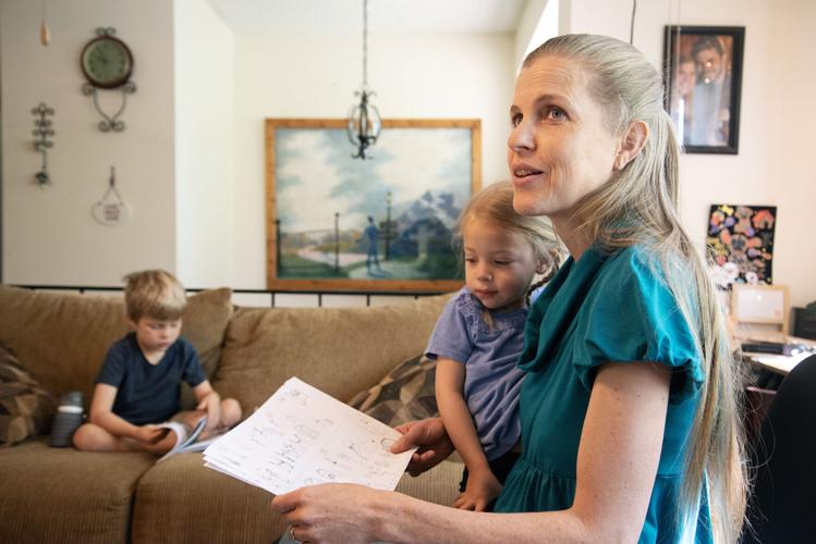 Stacie Graber looks over symbols to a hymn with her daughter Corrie