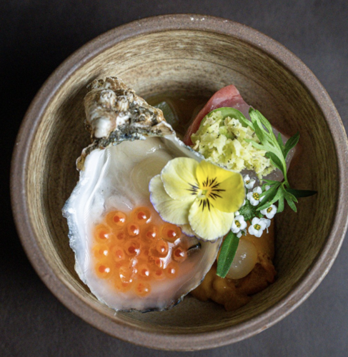 Oyster with Salmon Roe and Edible Flowers Served in Ceramic Bowl