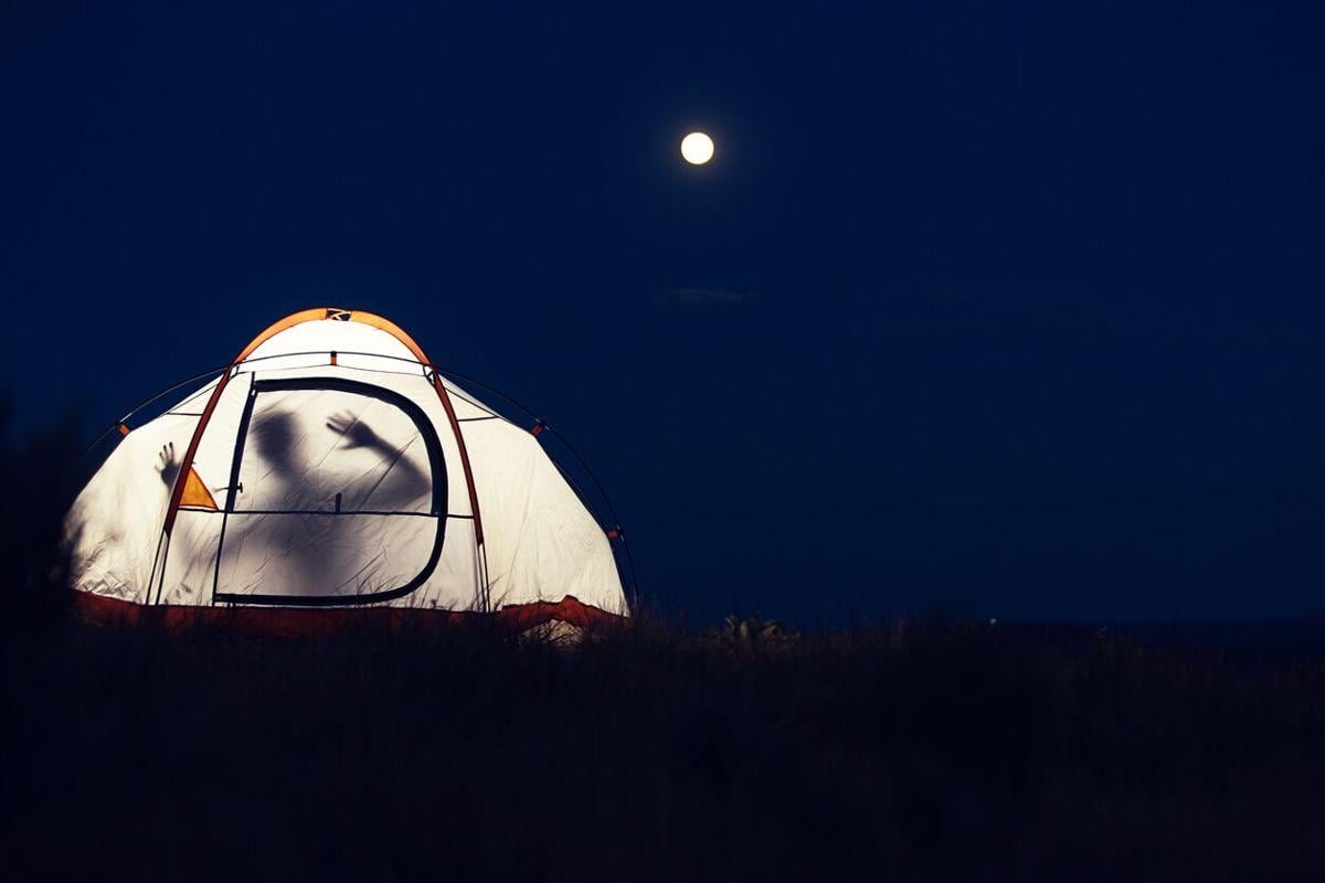 Lit up tent with spooky man Photo Credit: MivPiv (iStock).