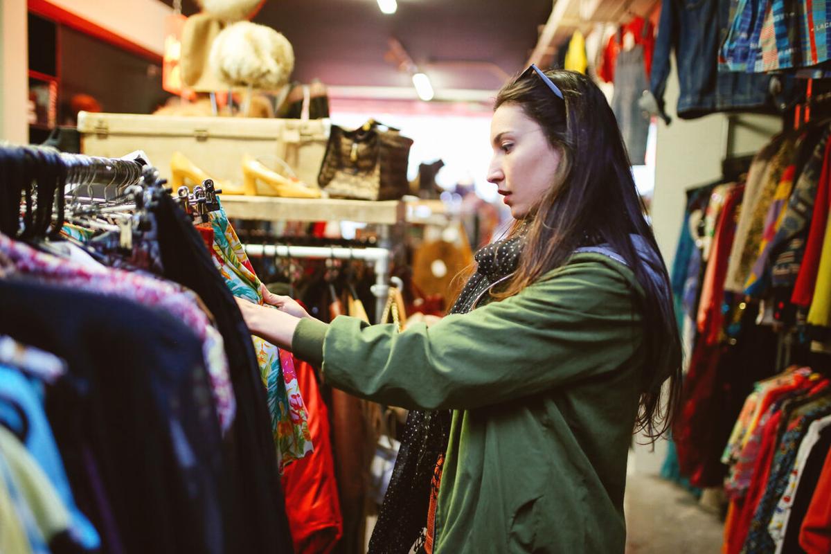 Woman shopping in London second hand marketplace Photo Credit: lechatnoir (iStock).