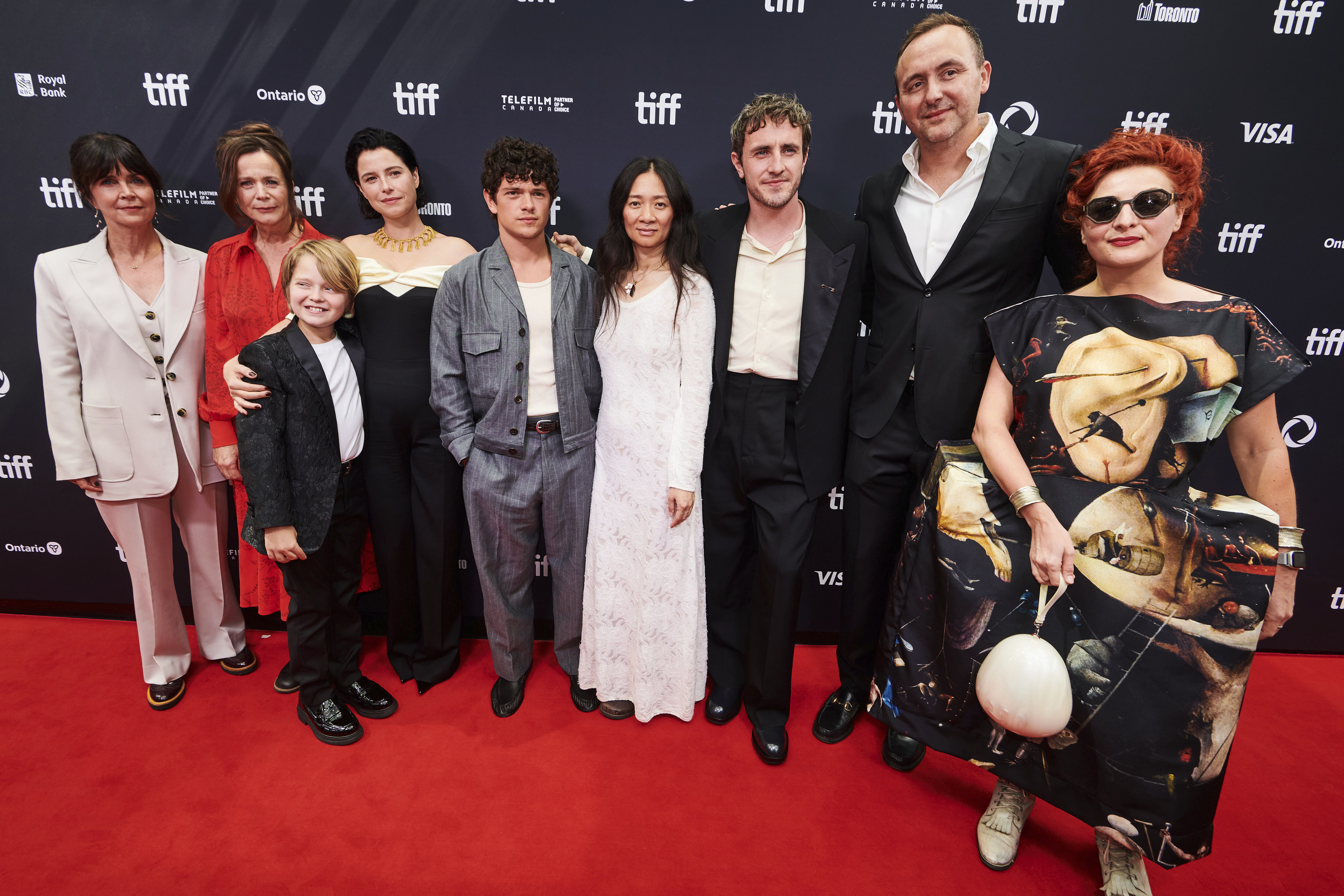 Producer Liza Marshall, left to right, actor Emily Watson, actor Jacobi Jupe, actor Jessie Buckley, actor Noah Jupe, director Chloé Zhao, actor Paul Mescal, producer Nic Gonda and costume designer Malgosia Turzanska are photographed on the red carpet for the film