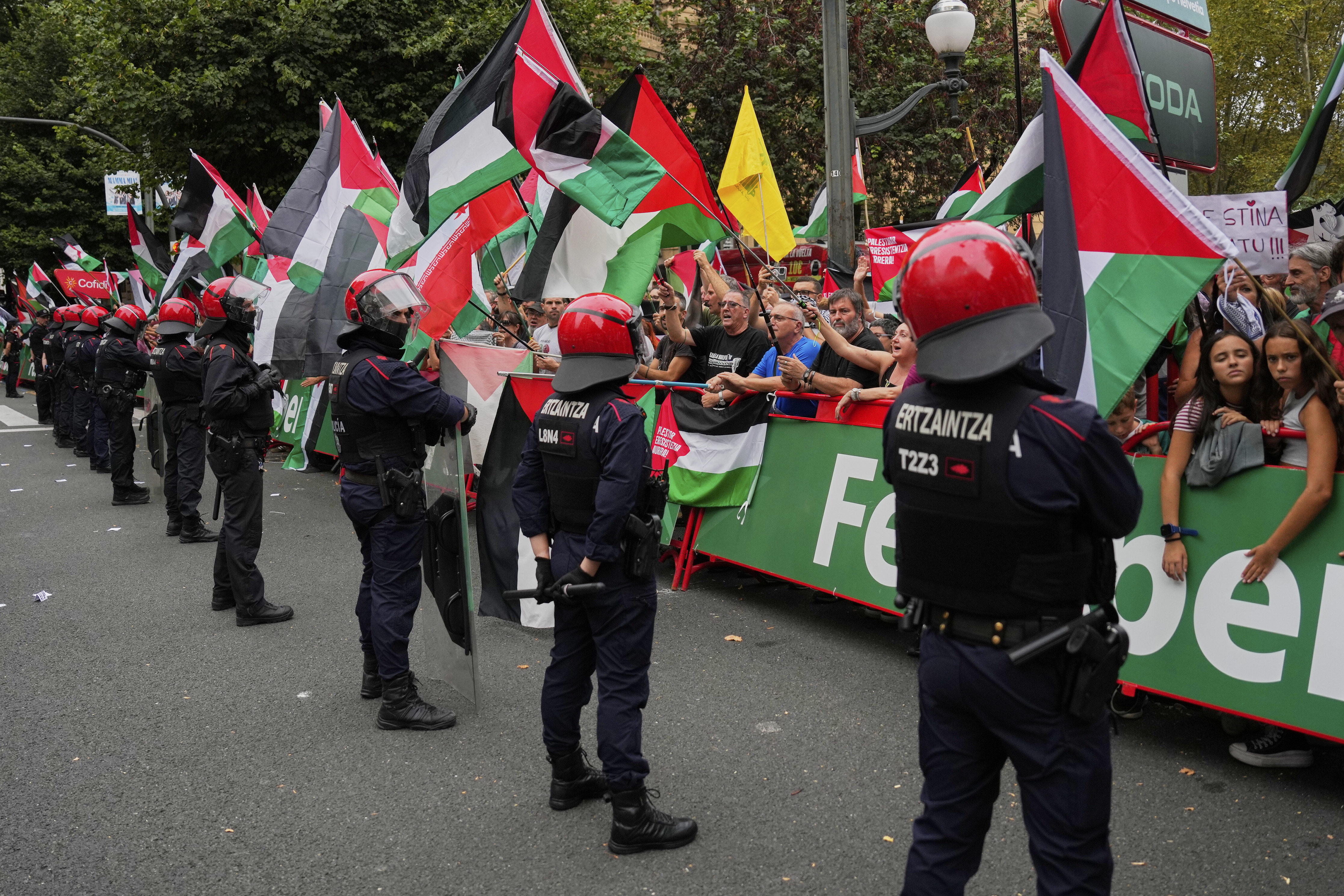 People hold Palestinian flags during the eleventh stage of the Spanish Vuelta cycling race, from Bilbao to Bilbao, Spain, Wednesday, Sept. 3, 2025. (Miguel Oses - AP)
