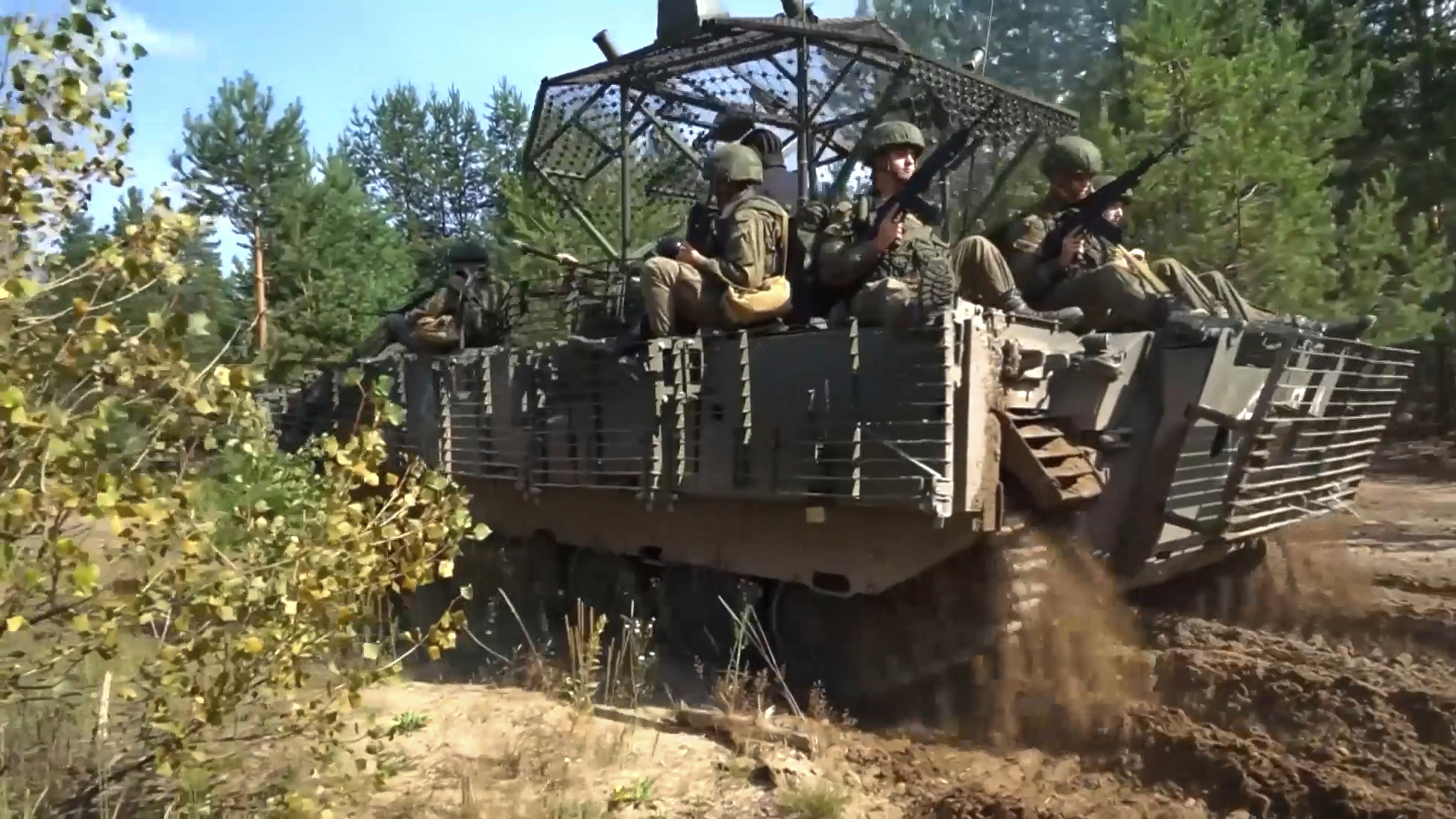 In this photo taken from video distributed by Russian Defense Ministry Press Service on Friday, Sept. 12, 2025, Armored vehicles drive during joint military drills held by Russia and Belarus. (Uncredited - Russian Defense Ministry Press Service)