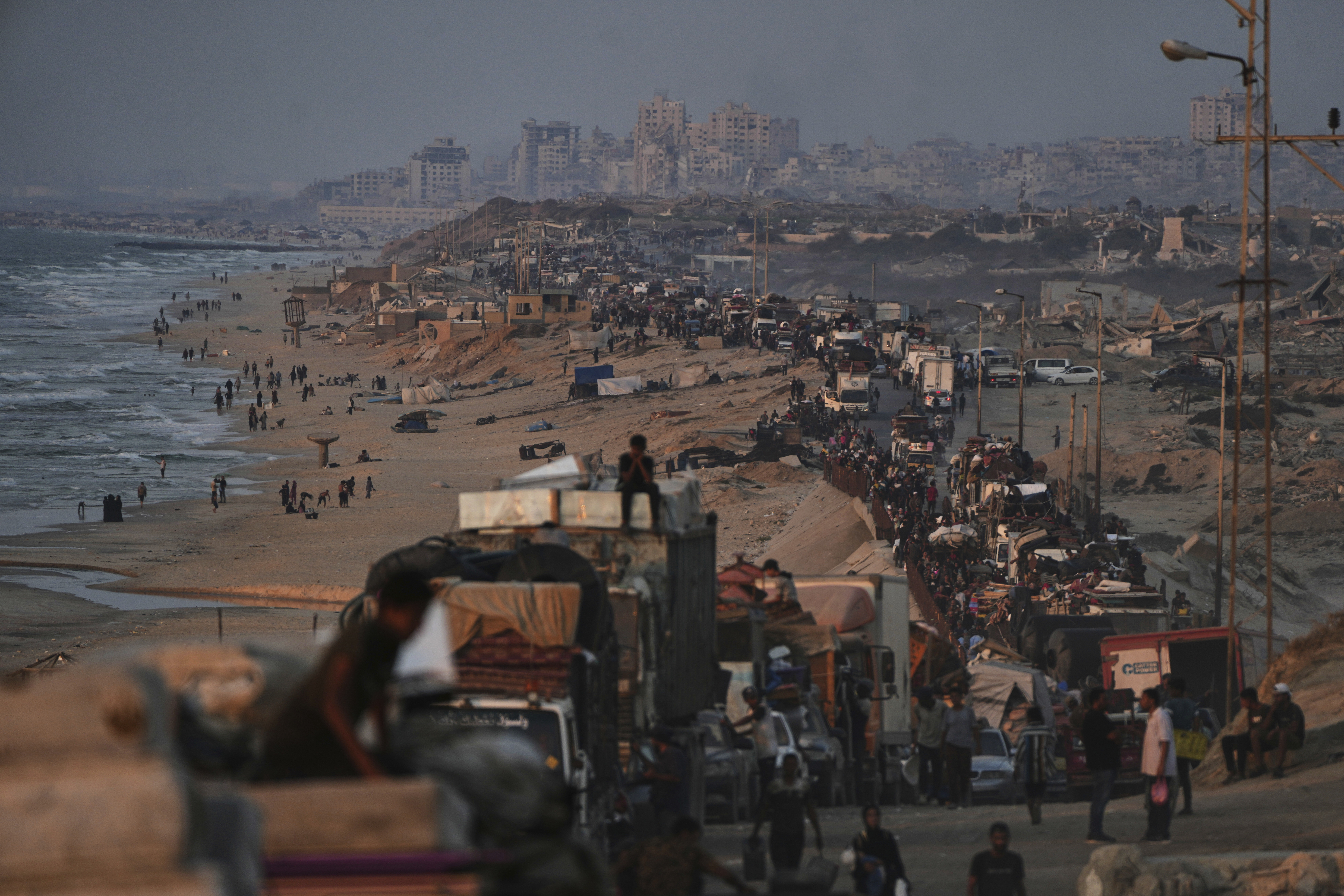 Displaced Palestinians flee Gaza City by foot and vehicles, carrying their belongings along the coastal road toward southern Gaza, Thursday, Sept. 18, 2025. (Abdel Kareem Hana - AP)