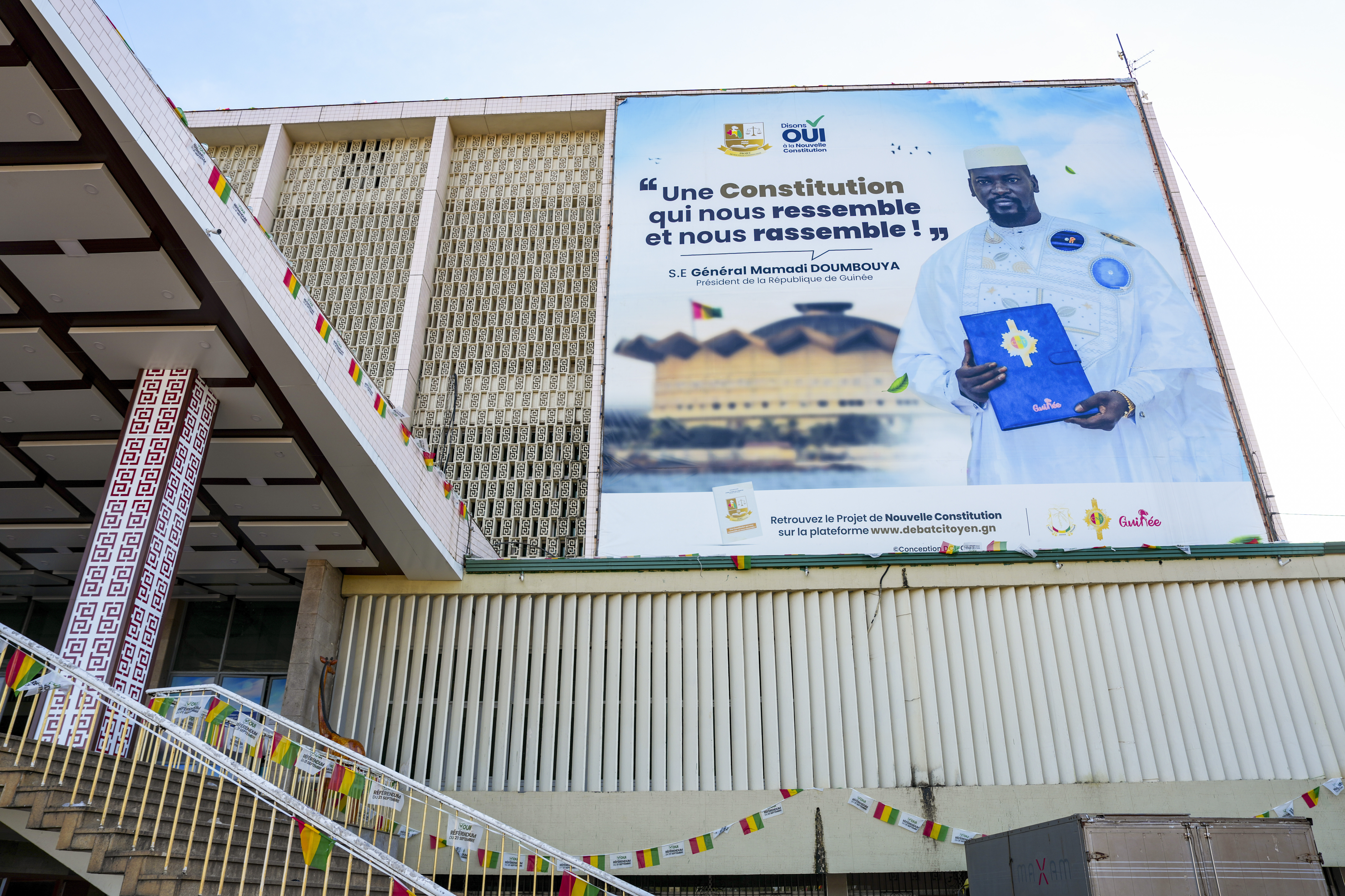 CORRECTS TITLE OF MILITARY LEADER A large campaign banner showing Guinea's interim president, Gen. Mamadi Doumbouya, is displayed on a public building in Conakry, Guinea, Wednesday, Sept. 17, 2025. (Misper Apawu - AP)