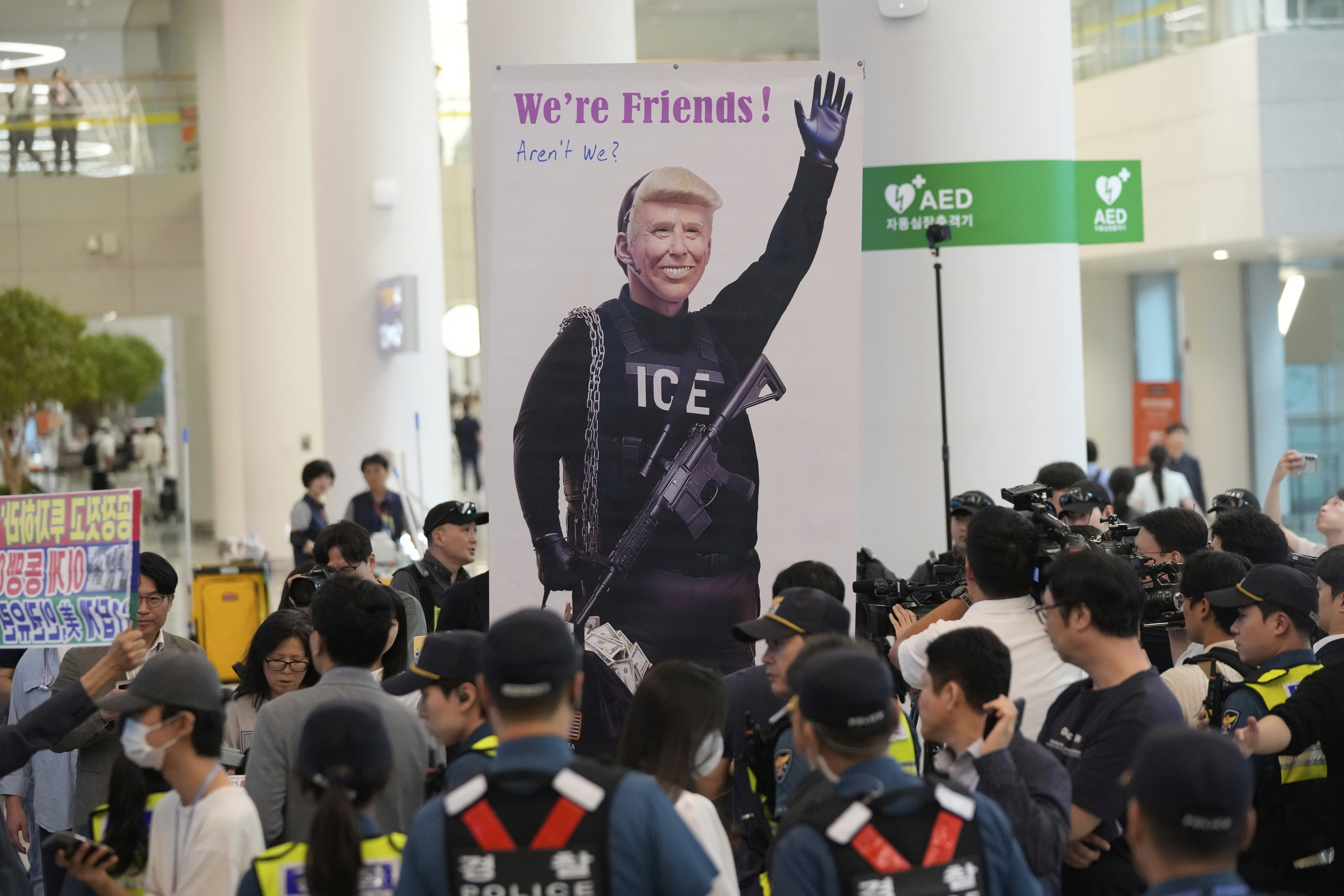 A banner depicting U.S. President Donald Trump is seen at the arrival terminal of the Incheon International Airport, in Incheon, South Korea, Friday, Sept. 12, 2025. (Ahn Young-joon - AP)