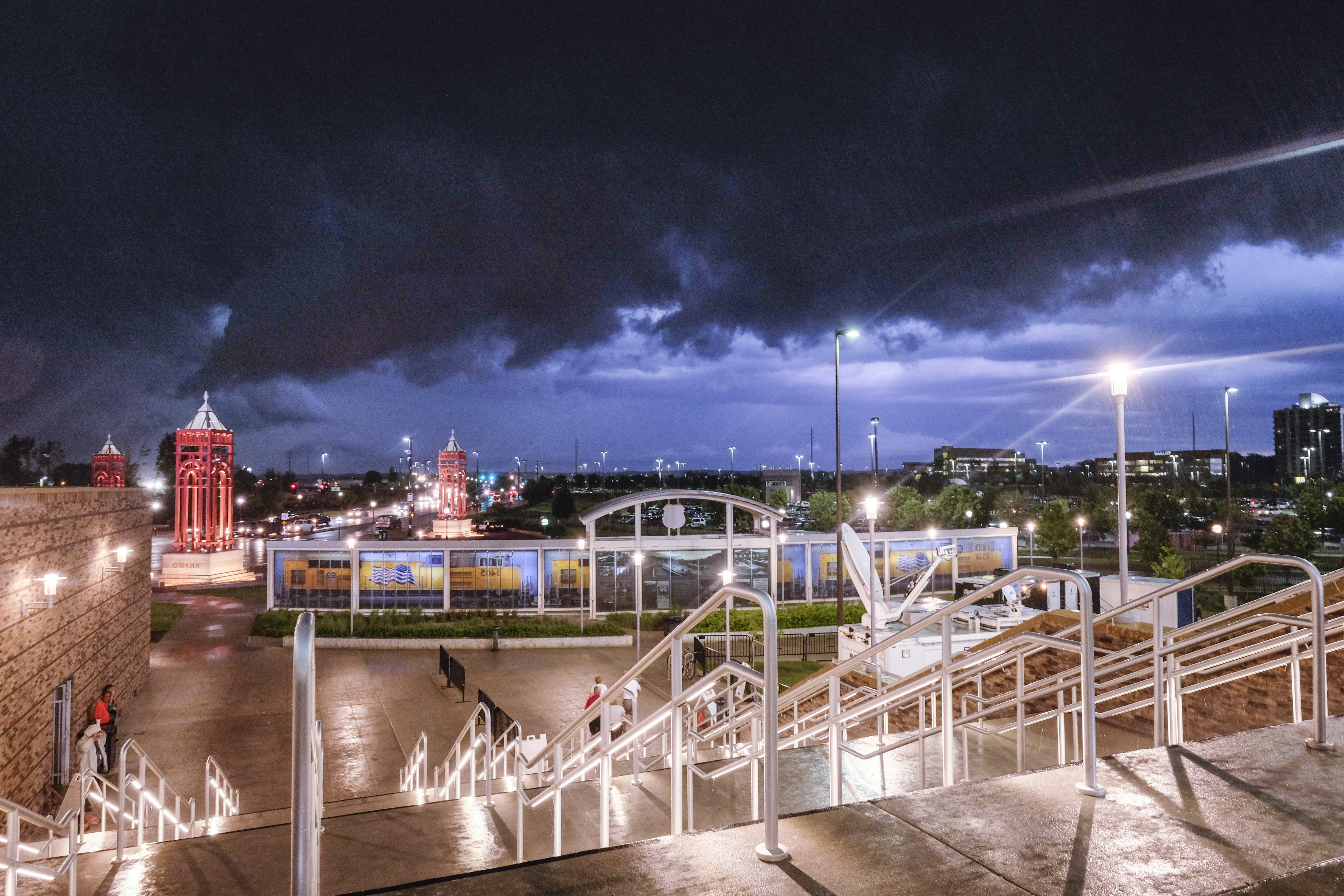 FILE - Dark storm clouds hang over TD Ameritrade Park and the Omaha skyline in Omaha, Neb., Friday, June 20, 2014, as the rain starts coming down. (Eric Francis - FR9944 AP)