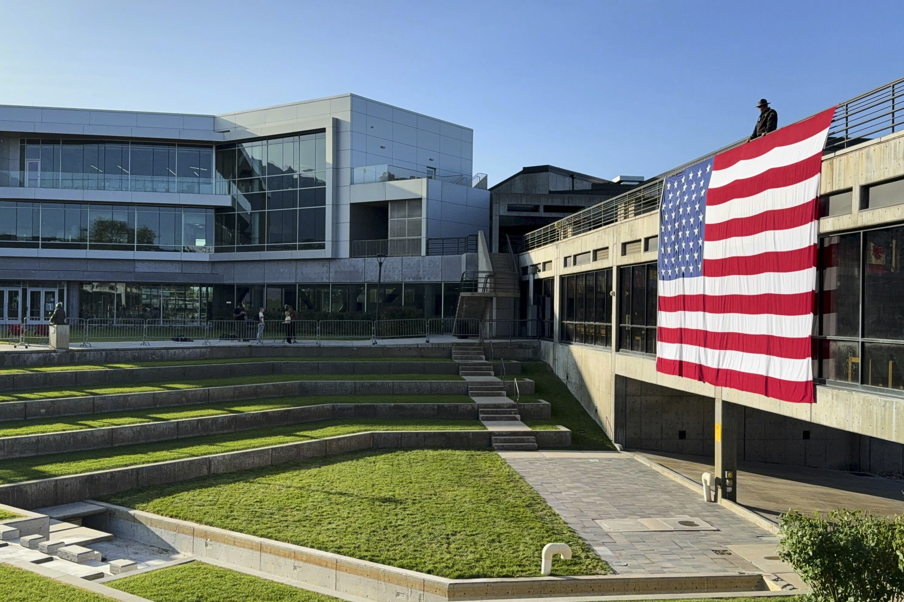 A national flag hangs over the site where conservative activist Charlie Kirk was shot and killed at Utah Valley University last week, Wednesday, Sept. 17, 2025, in Orem, Utah. (Jesse Bedayn - AP)
