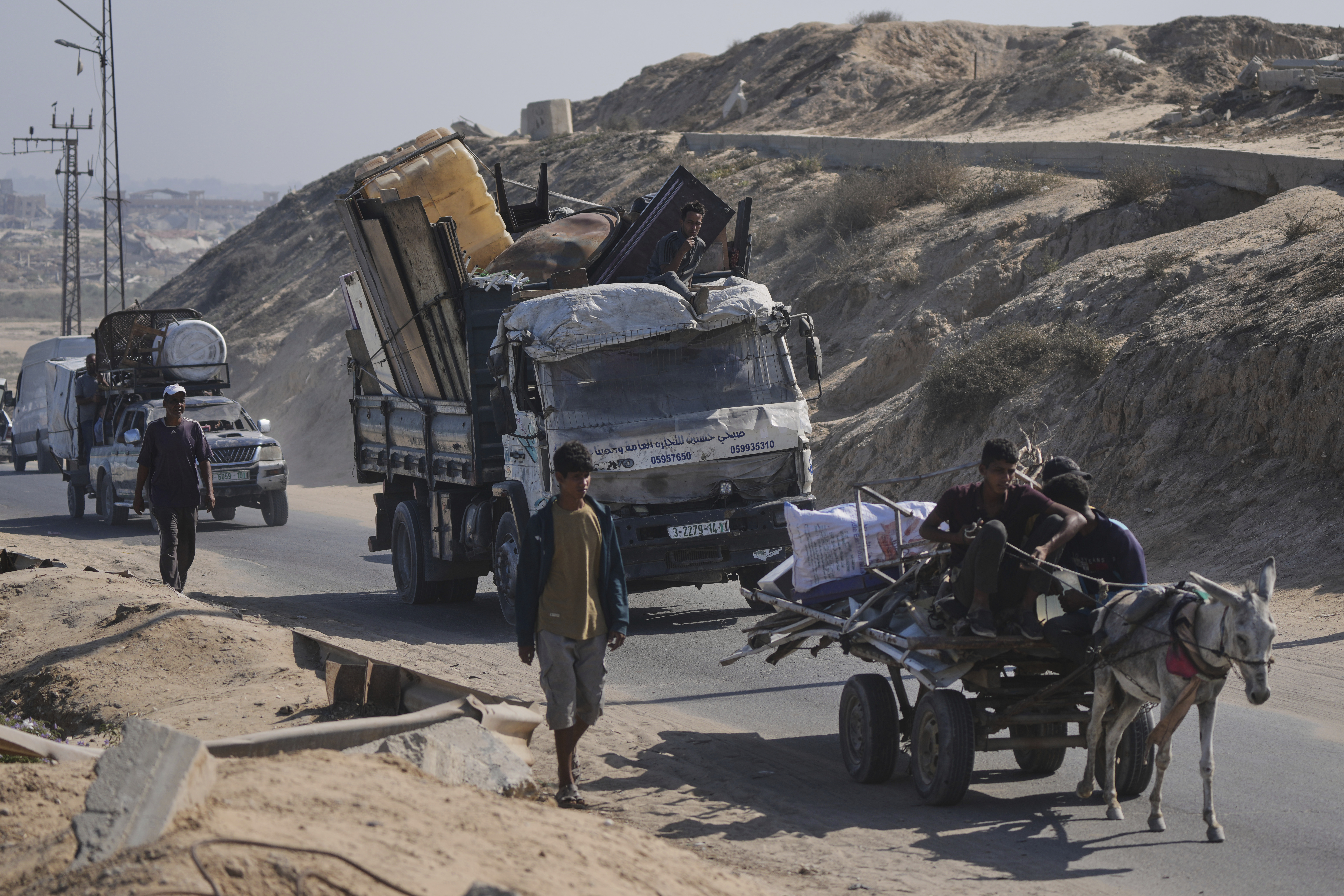 Displaced Palestinians fleeing northern Gaza carry their belongings along the coastal road toward southern Gaza, Tuesday, Sept. 9, 2025, after the Israeli army issued evacuation orders from Gaza City. (Jehad Alshrafi - AP)