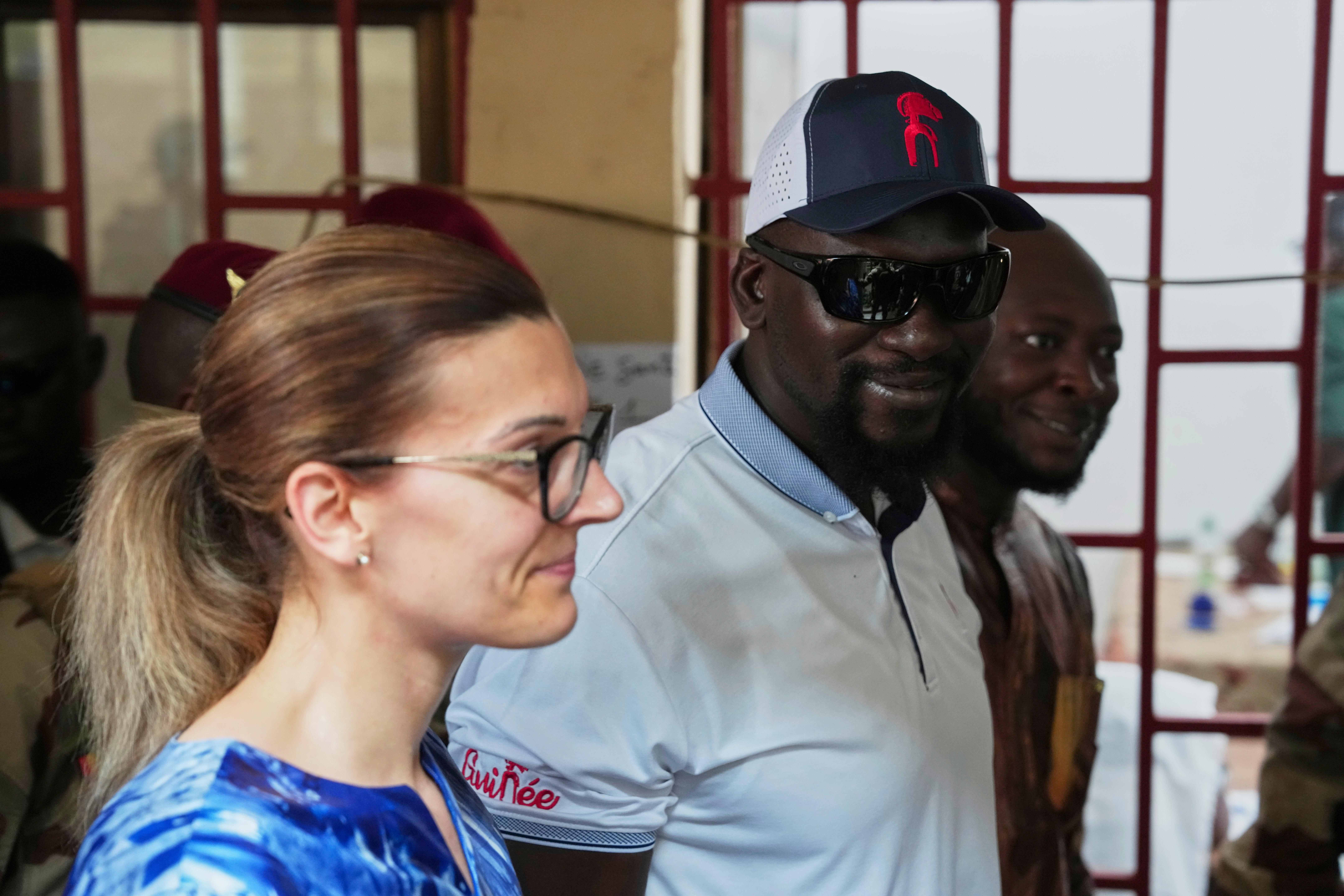 Guinea's interim President, Gen. Mamadi Doumbouya, departs with his wife after casting his vote in the constitutional referendum in Conakry, Guinea, Sunday, Sept. 21, 2025 (Misper Apawu - AP)