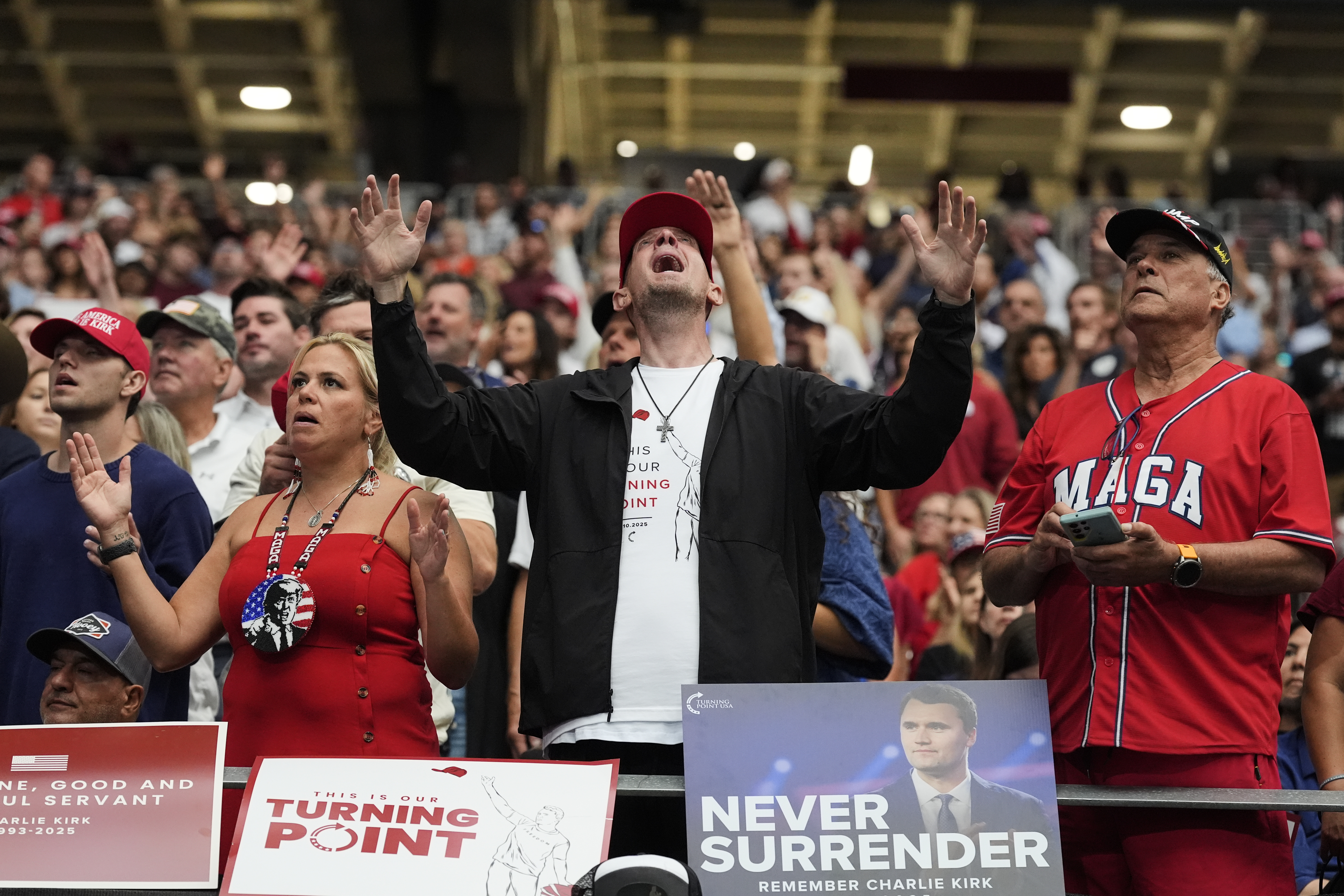 A man listens during a worship song before the start of a memorial for conservative activist Charlie Kirk, Sunday, Sept. 21, 2025, at State Farm Stadium in Glendale, Ariz. (Ross D. Franklin - AP)