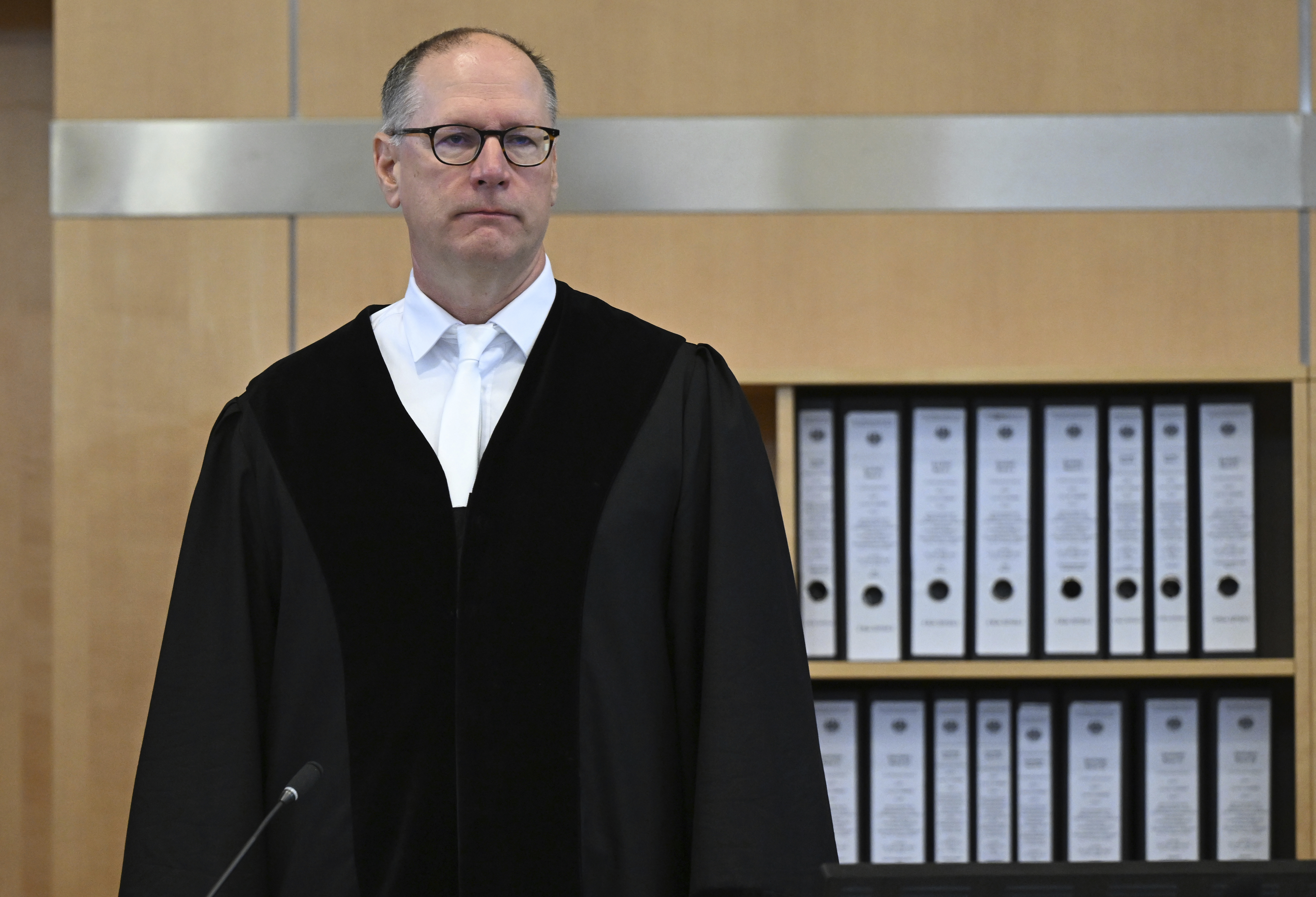 The presiding judge Winfried van der Grinten stands in the courtroom at the start of the hearing of the 27-year-old man who is alleged to have stabbed three people to death at the city festival