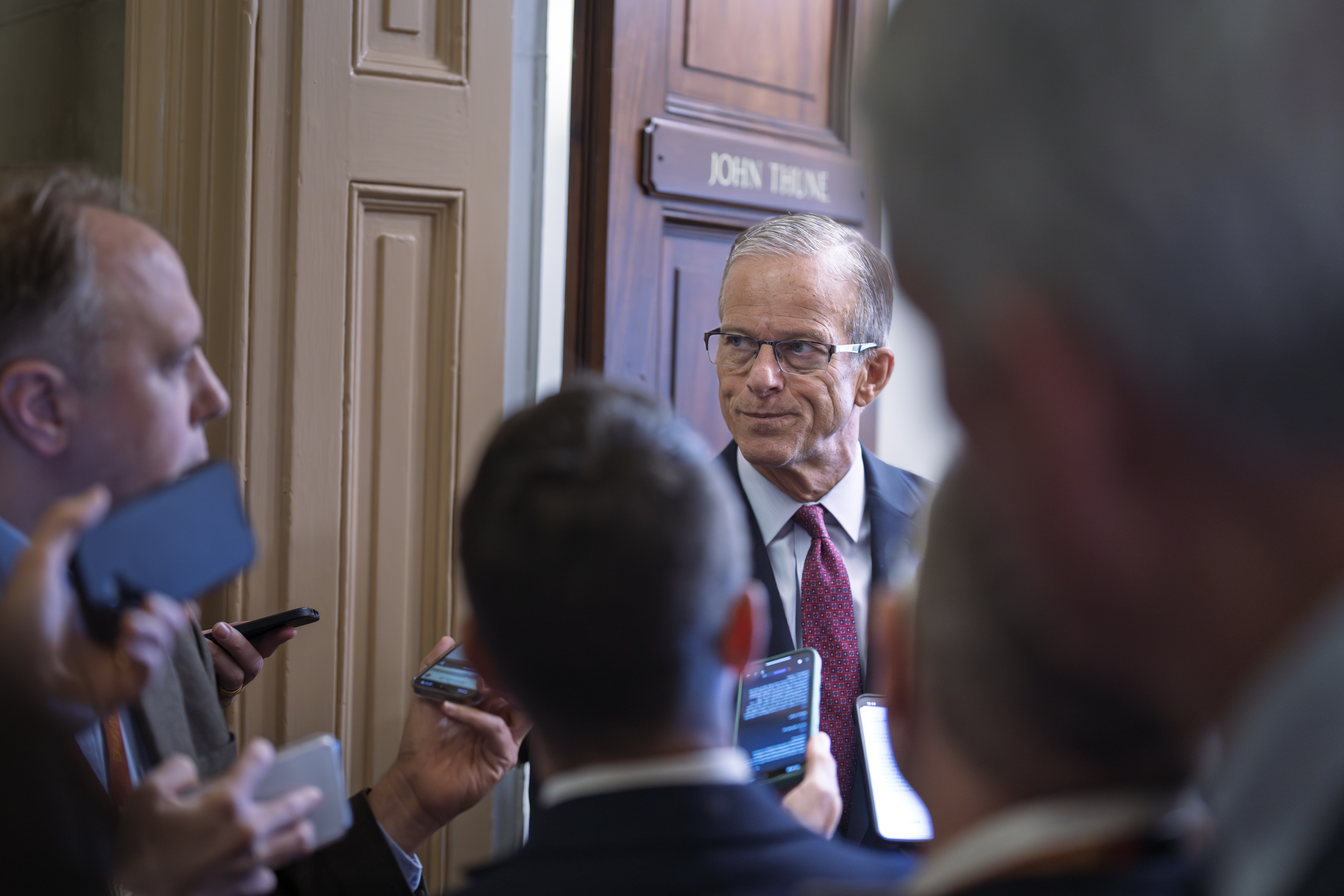 Senate Majority Leader John Thune, R-S.D., is met by reporters as he walks to his office while Congress works on a government funding solution, at the Capitol in Washington, Thursday, Sept. 18, 2025. (J. Scott Applewhite - AP)