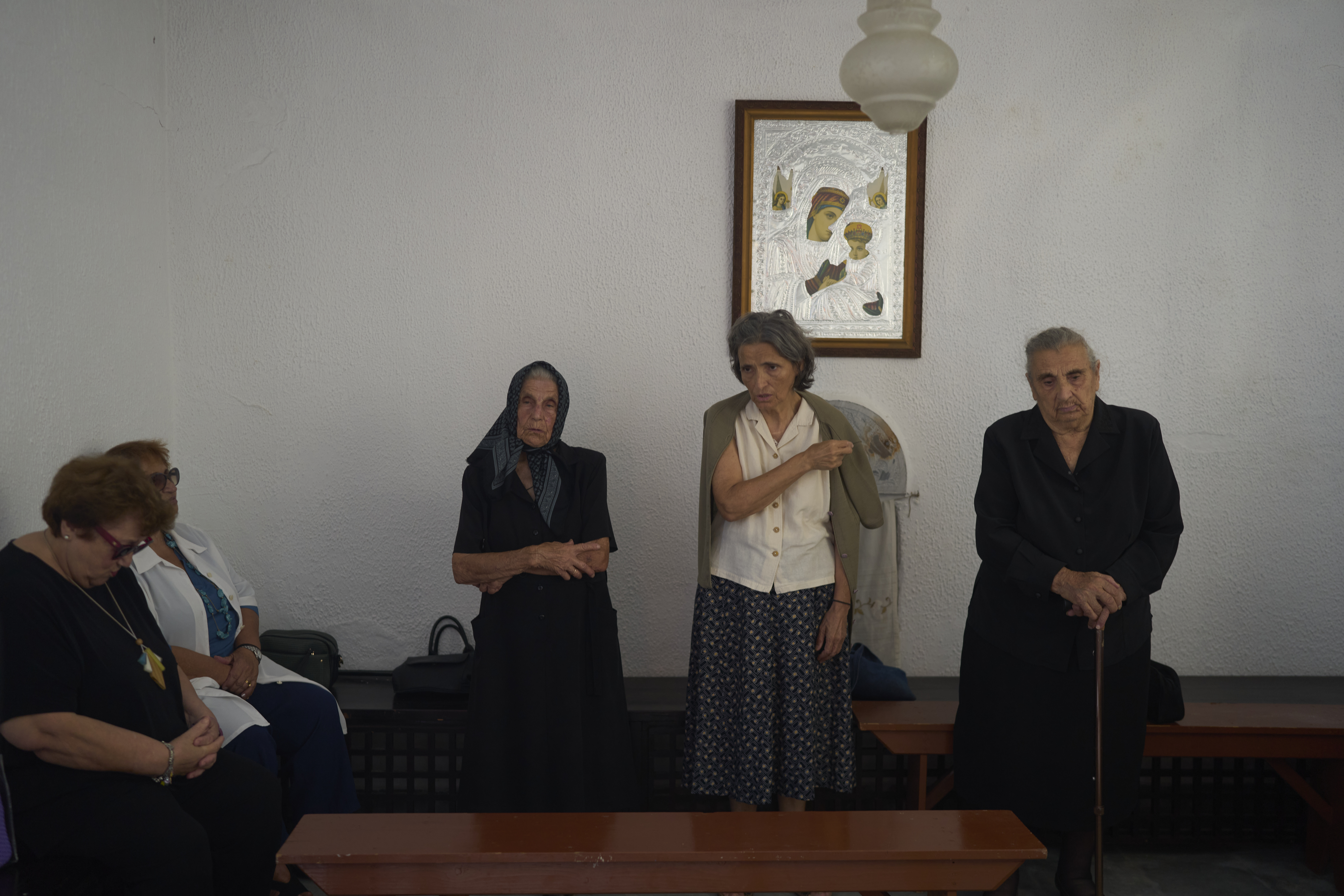 Worshippers make the Sign of the Cross during a liturgy at the family-owned Agios Sostis chapel on the island of Tinos, Greece, Monday, Sept. 8, 2025. (Petros Giannakouris - AP)