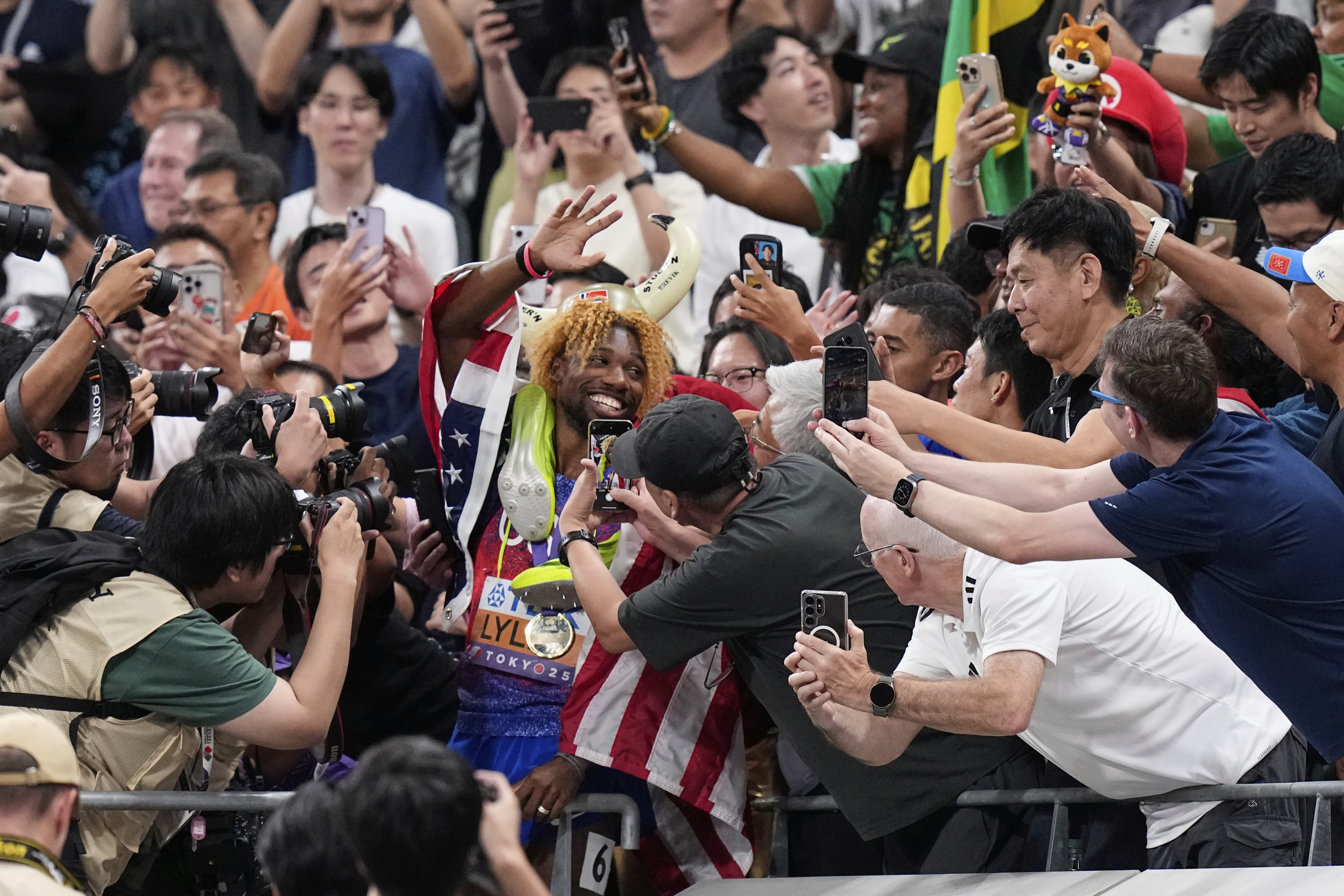 United States' Noah Lyles celebrates with his supporters after winning gold medal in the men's 200 meters final at the World Athletics Championships in Tokyo, Friday, Sept. 19, 2025. (Eugene Hoshiko - AP)