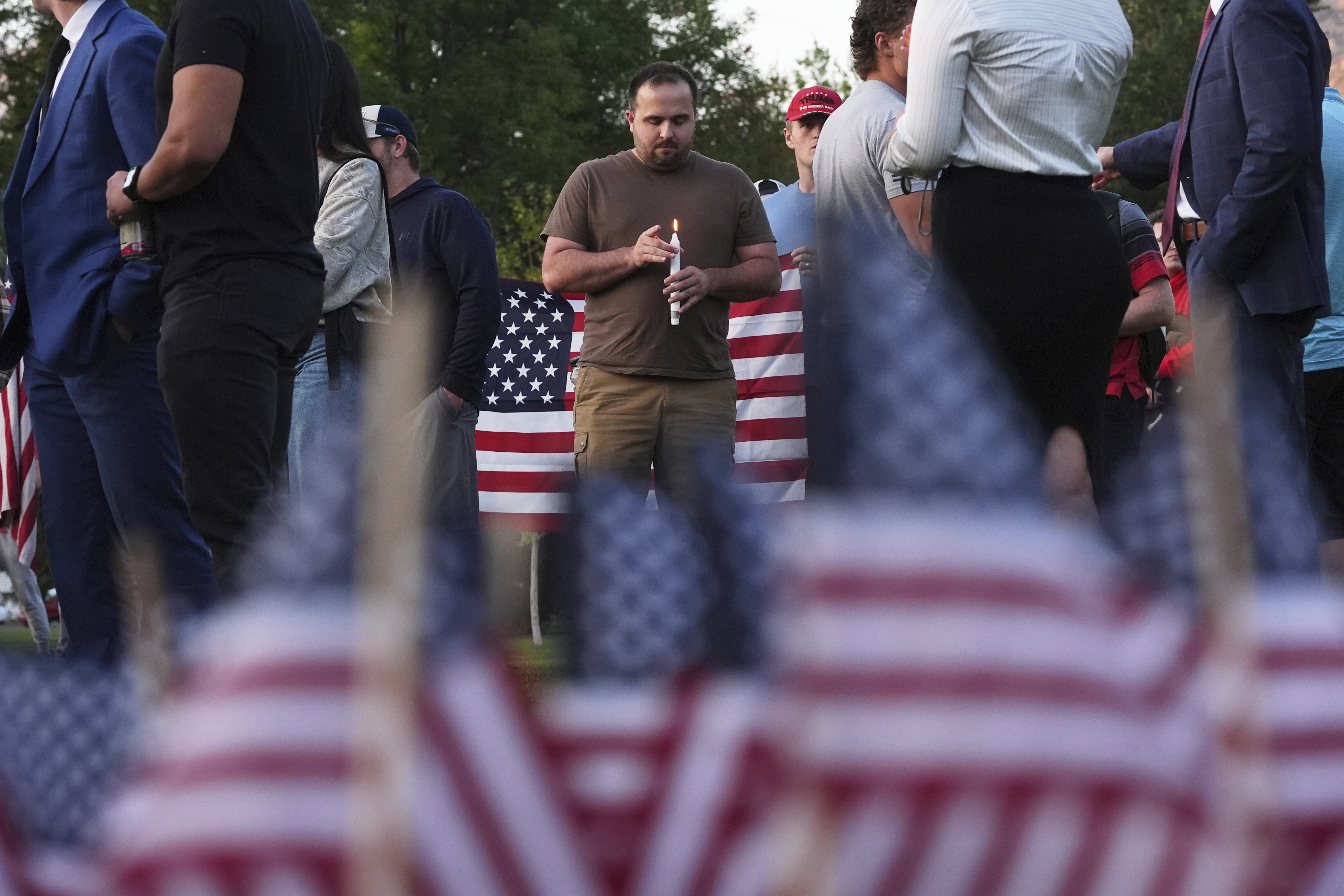 A man holds a candle as attendees pay their respects during a vigil for Charlie Kirk on Friday, Sept. 12, 2025, in Provo, Utah. (Lindsey Wasson - AP)
