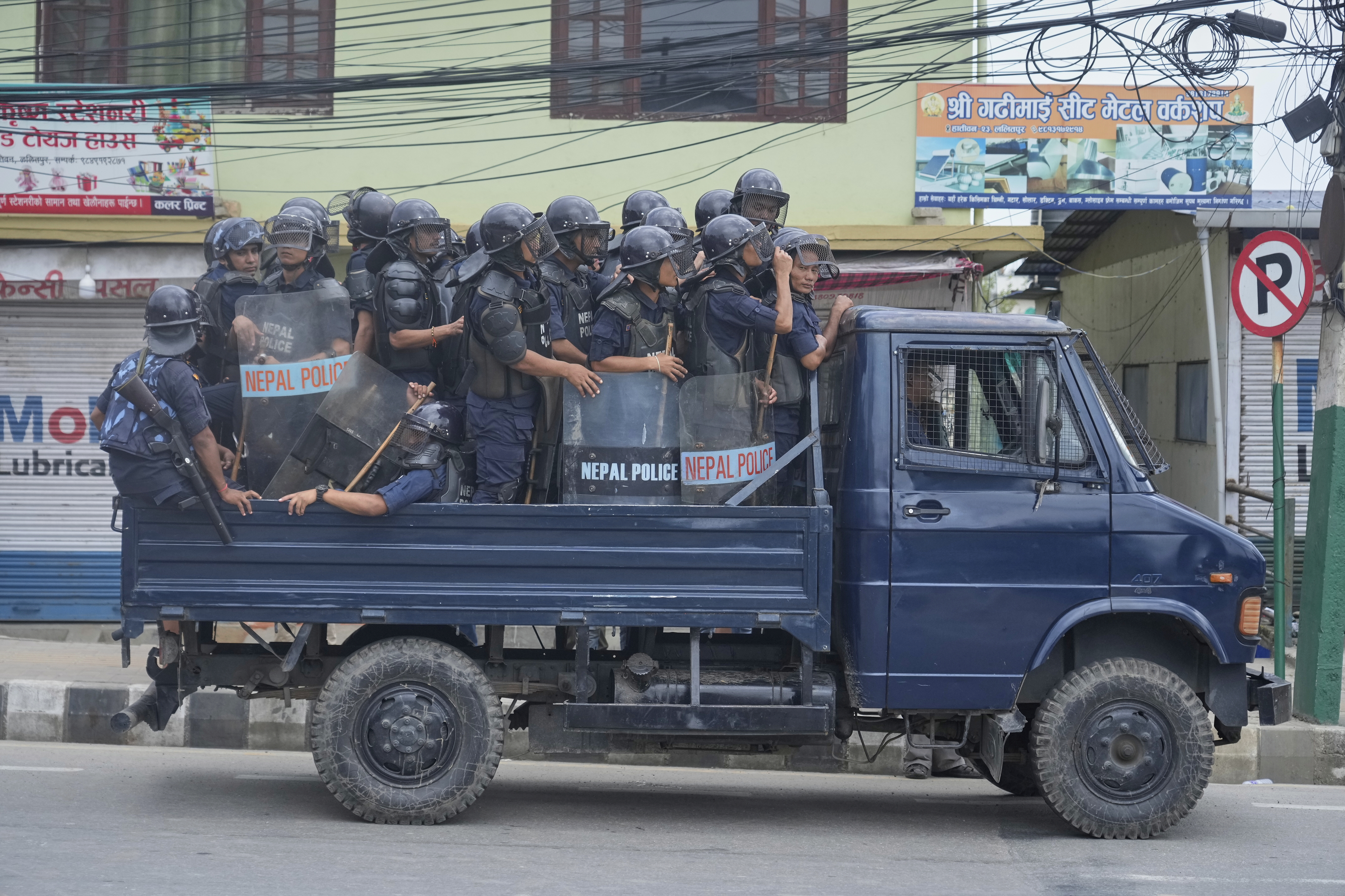 Policemen in riot gear patrol in a vehicle during curfew orders in Kathmandu, Nepal, Tuesday, Sept. 9, 2025. after Nepal’s government lifted its ban on social media platforms after violent street protests. (Niranjan Shrestha - AP)