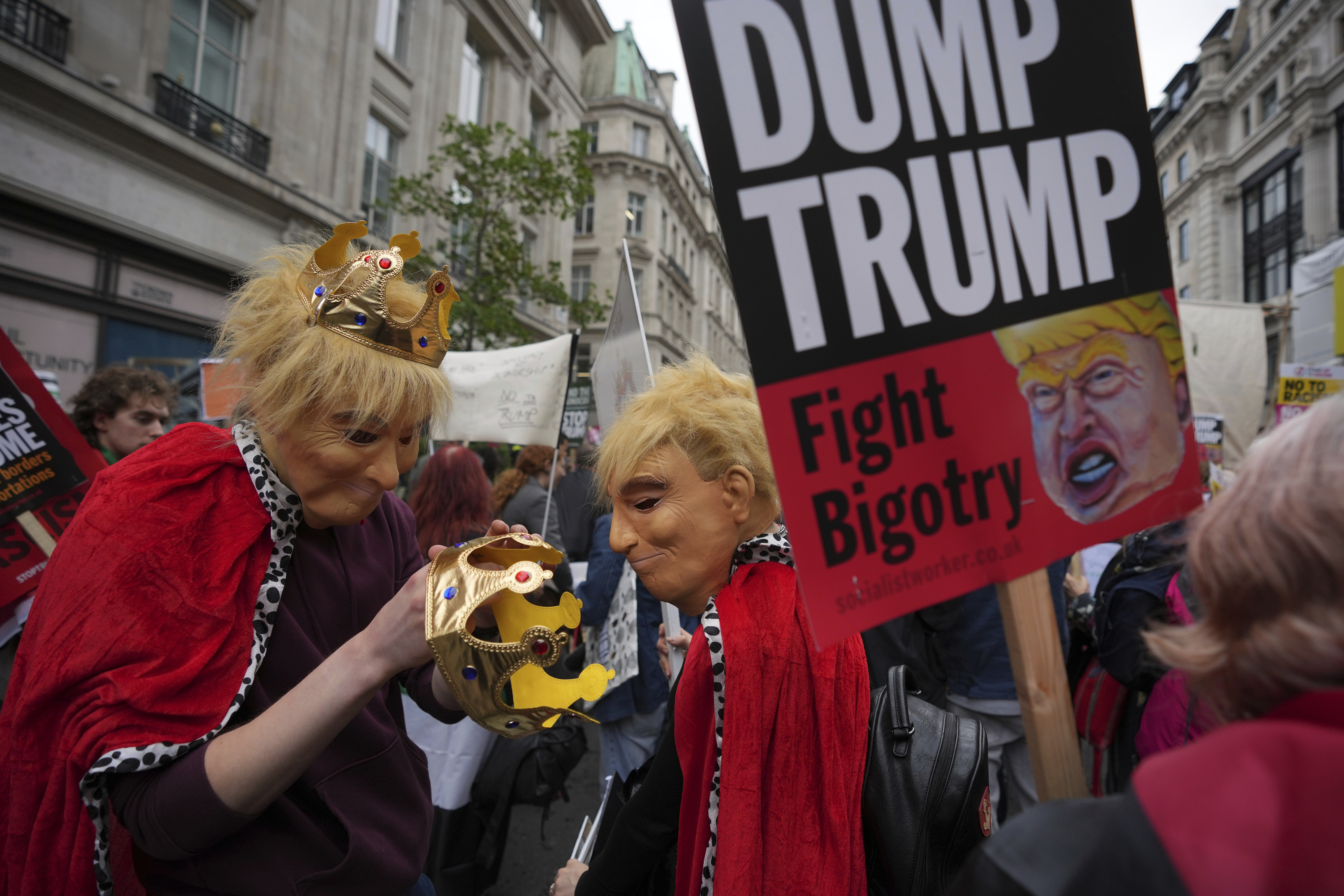 Protesters in costumes adjust their crowns during a demonstration of the Stop Trump Coalition group against President Donald Trump's state visit in London, Wednesday, Sept. 17, 2025. (Kin Cheung - AP)