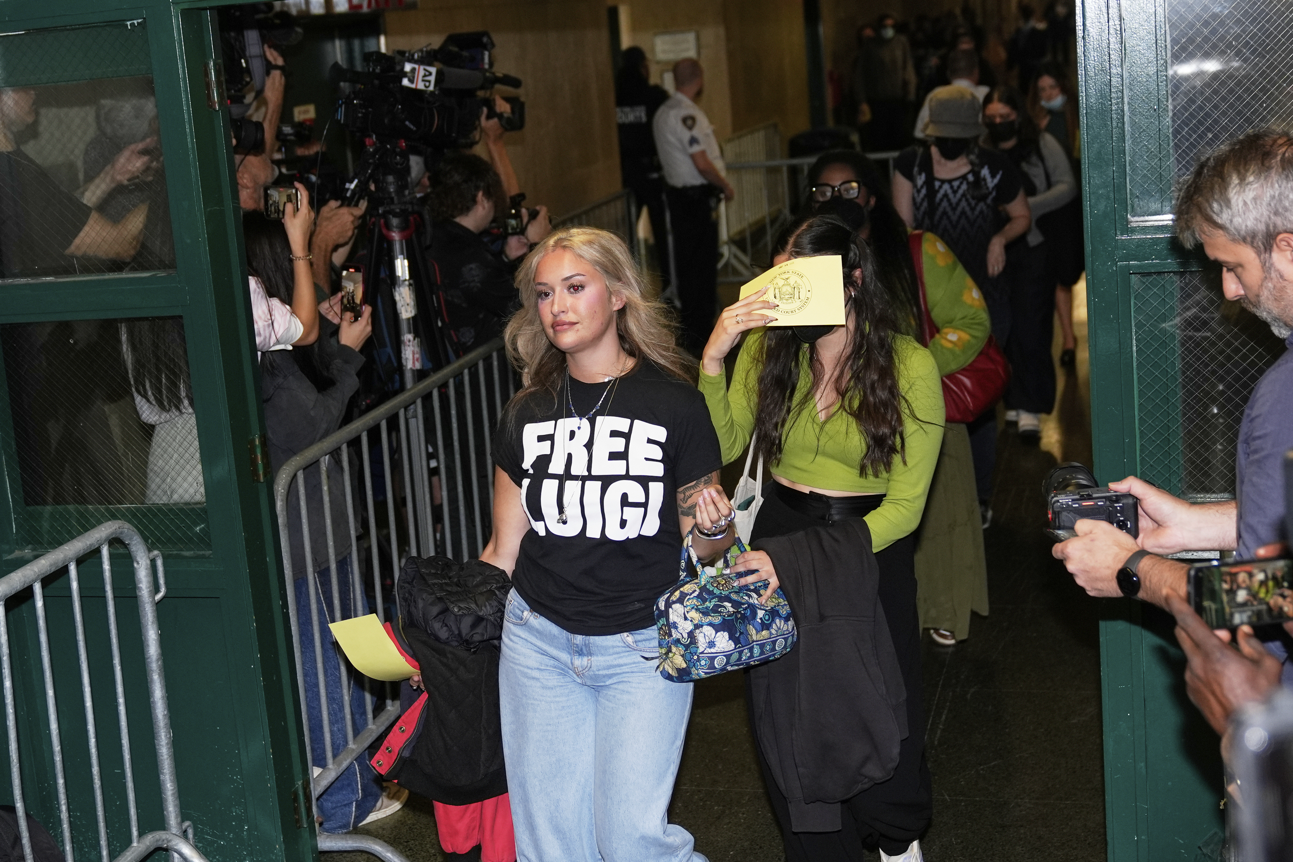 Members of the public, including a woman wearing a 