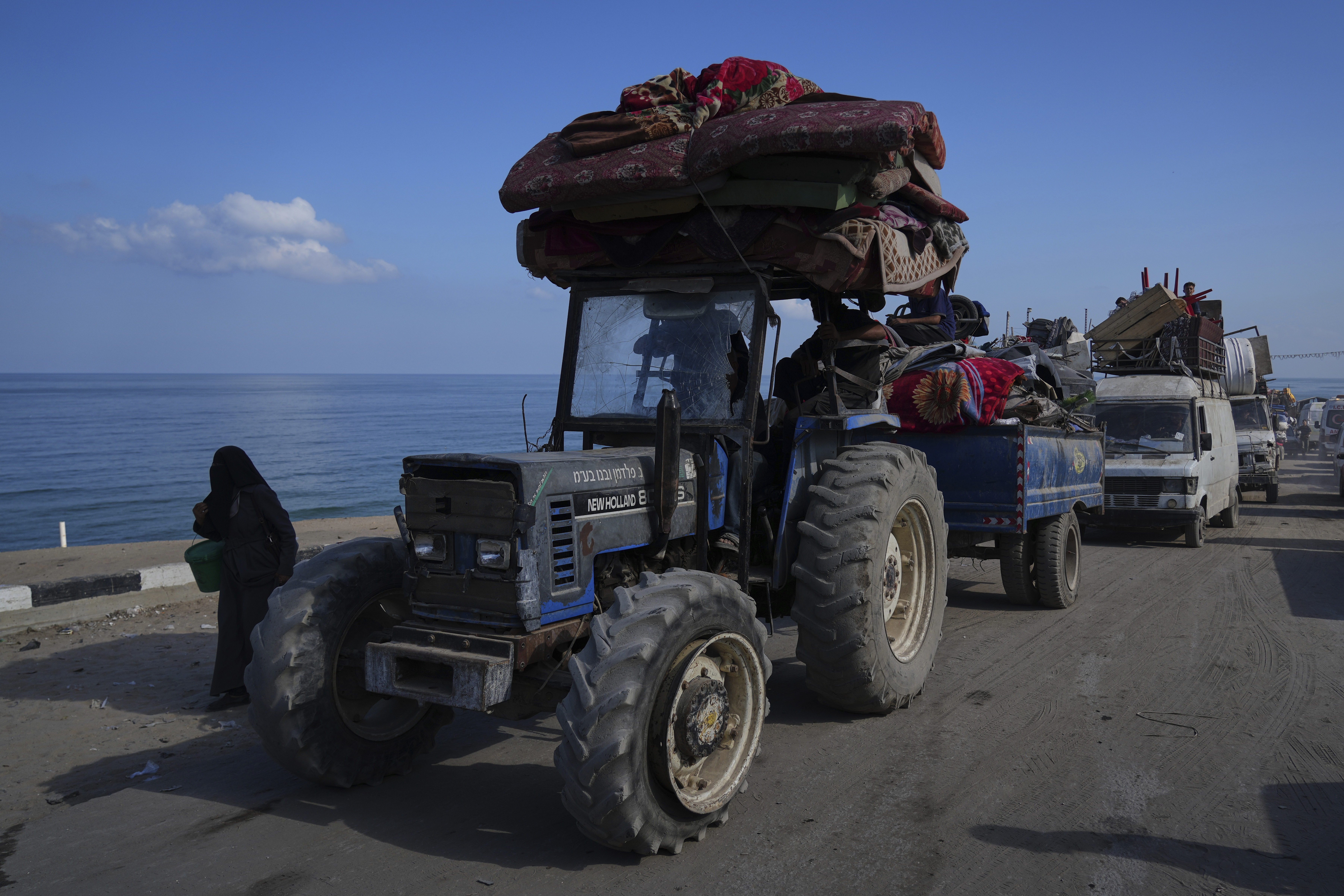 Displaced Palestinians carry their belongings as they flee northern Gaza along the coastal road toward the south, as Israel announced an expanded operation in Gaza City, Tuesday, Sept. 16, 2025. (Abdel Kareem Hana - AP)