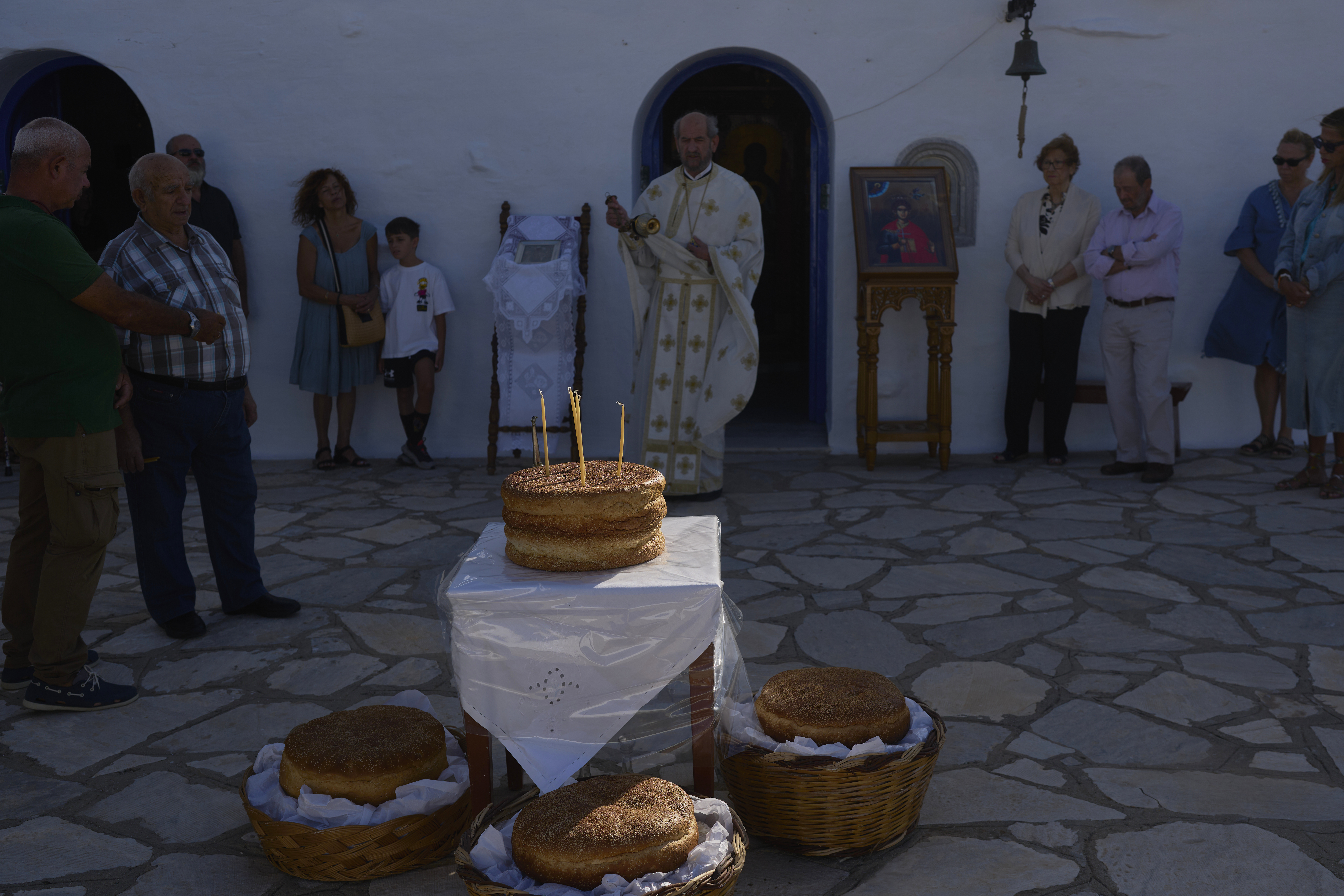 Greek Orthodox priest Antonios Stathopoulos swings a censer during a liturgy at the family-owned Agios Sostis chapel on the island of Tinos, Greece, Monday, Sept. 8, 2025. (Petros Giannakouris - AP)